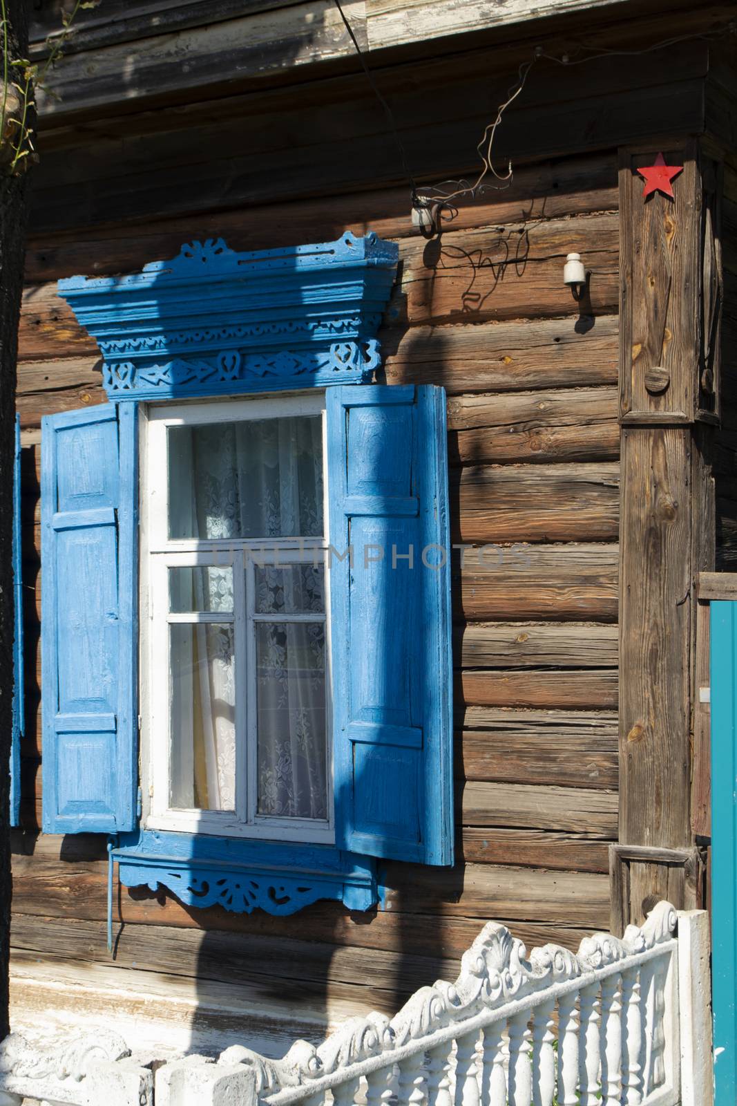 Vintage wooden carved window frame. Decorative lacy window frame in Belarus