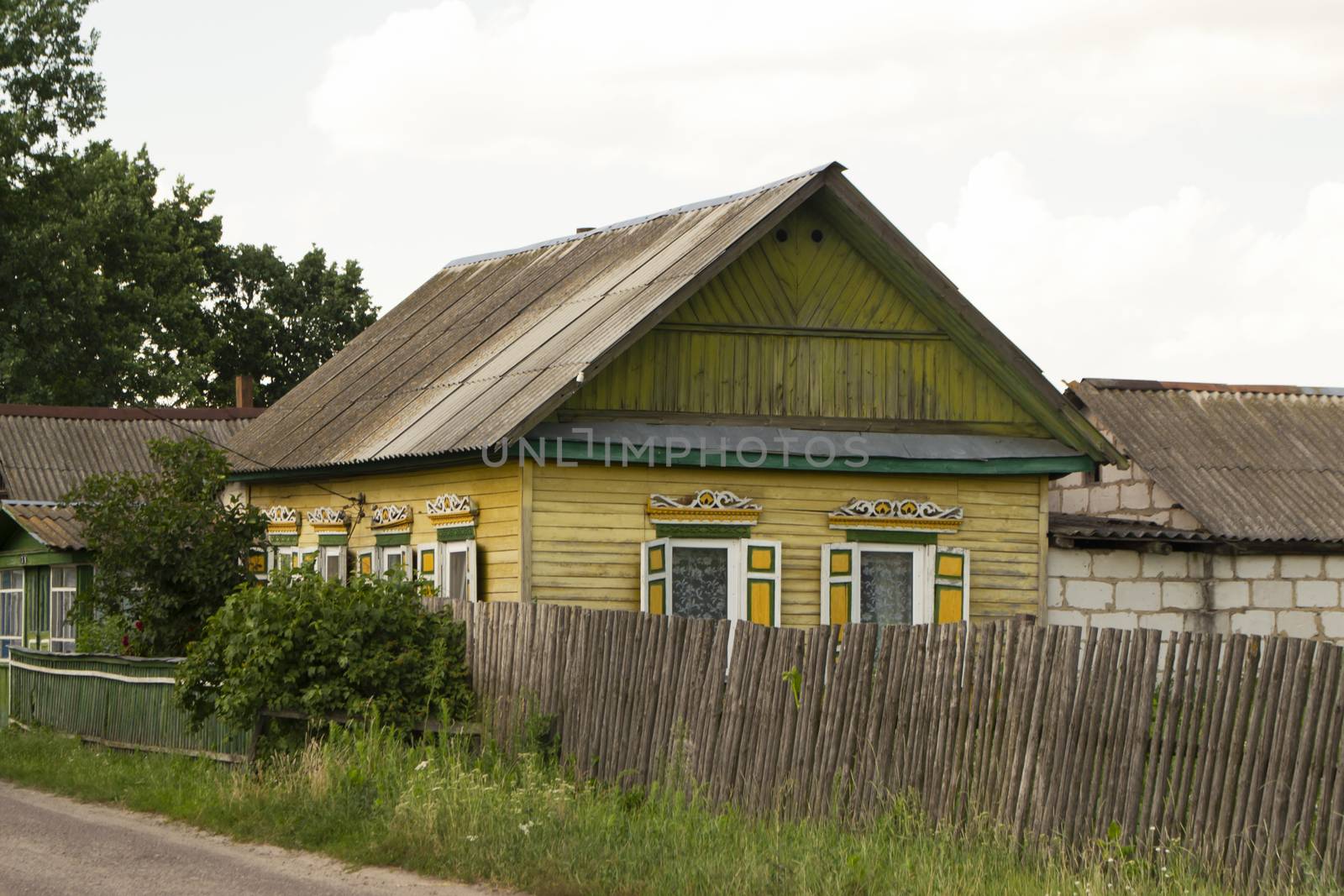 Authentic shabby wooden house with carved windows and decoration in Belarus
