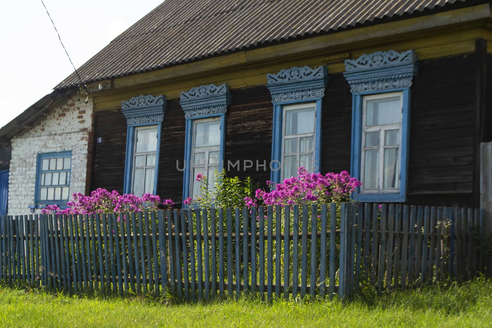 decorative carved window in an old wooden house, rustic decoration of a wooden house, Belarus