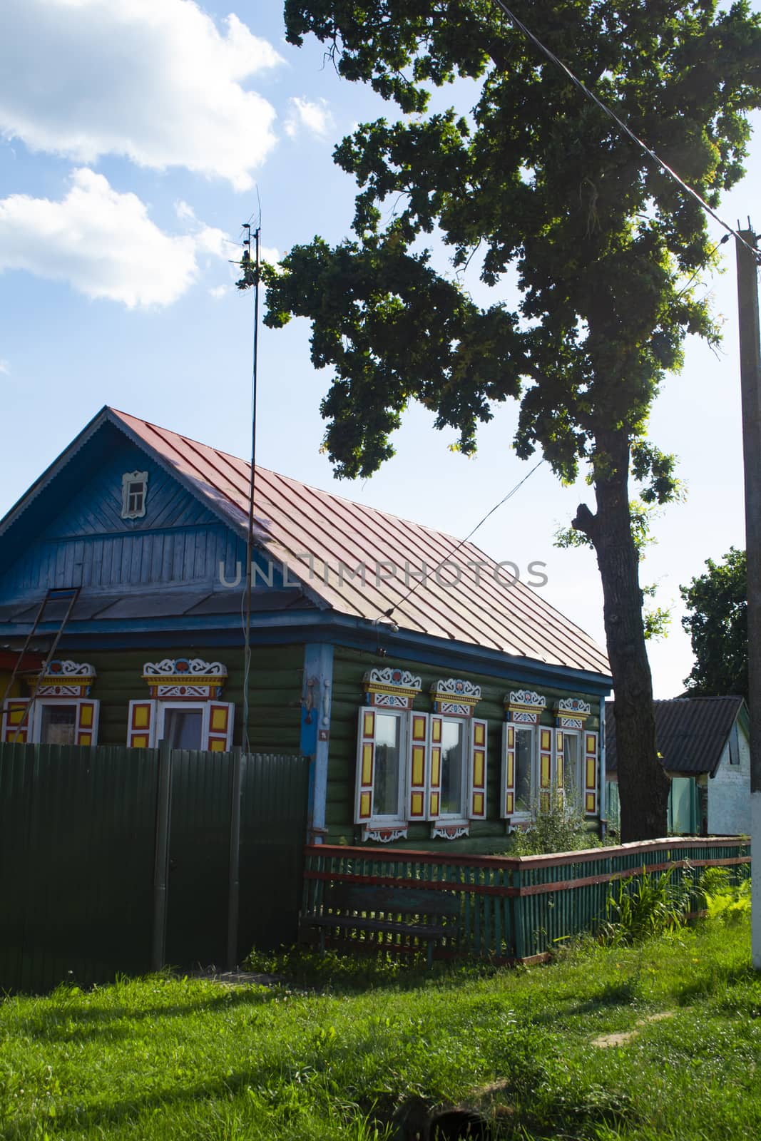 Rural wooden house with carved ornamental windows in village in Belarus