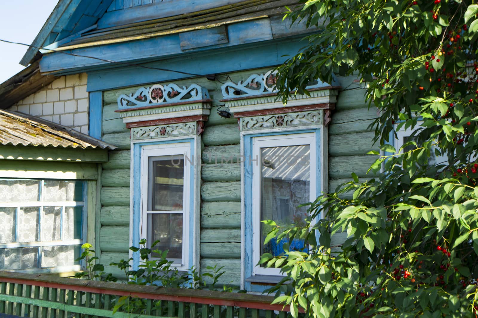 wall of wooden traditional russian house with windows and carved frames and pattern. Belarus authentic