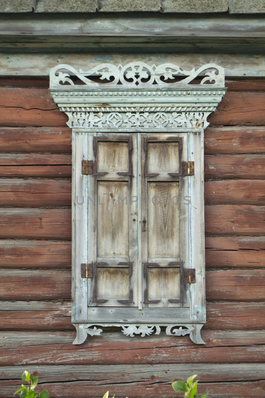 Old house vintage carved windows with wooden lacy shutters close up. Belarus