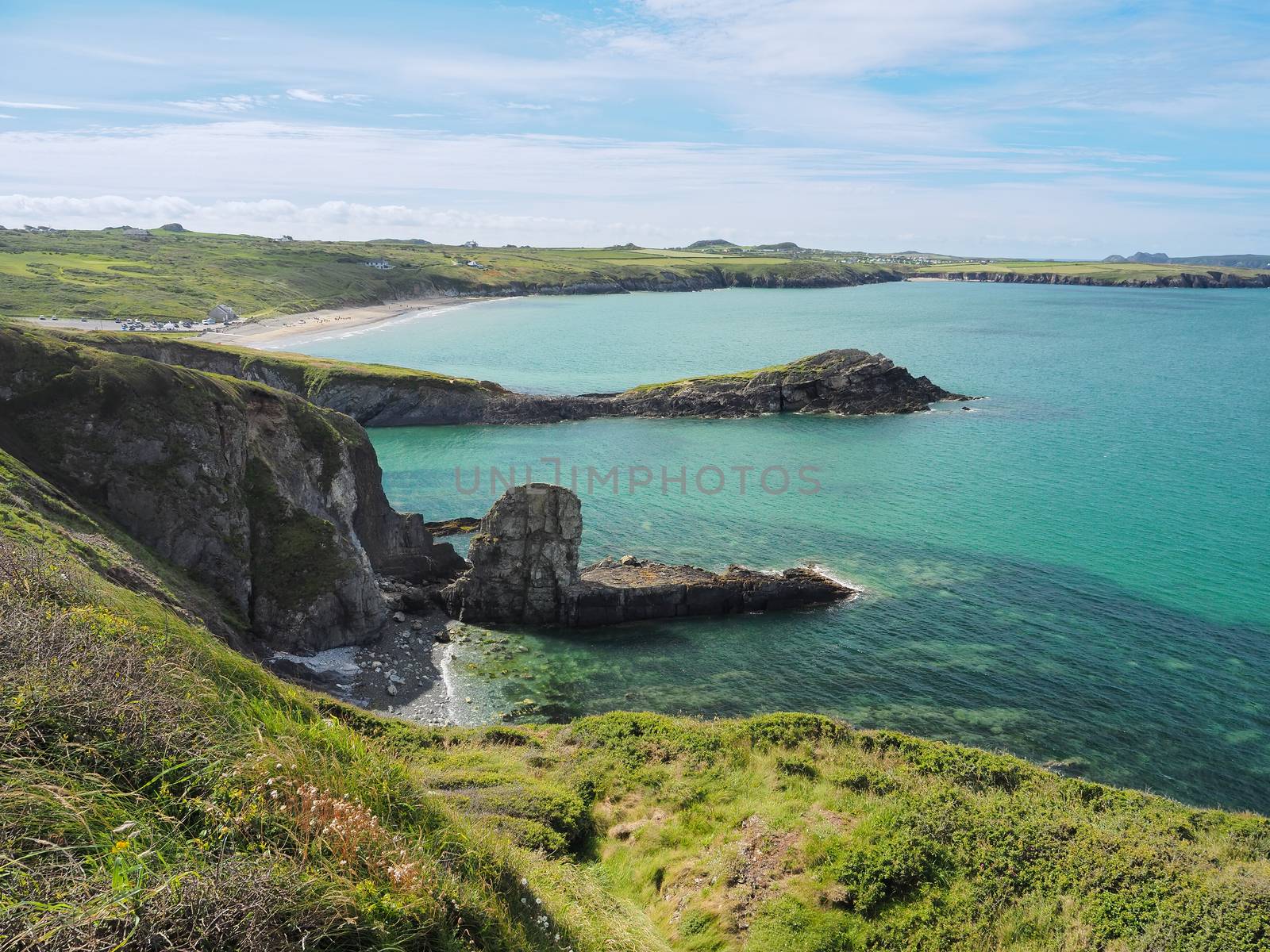 View from the coastal path around at St Davids Peninsula over the sandy beach of Whitesands Bay and dramatic cliffs and coves, Pembrokeshire Coast National Park, Wales, UK