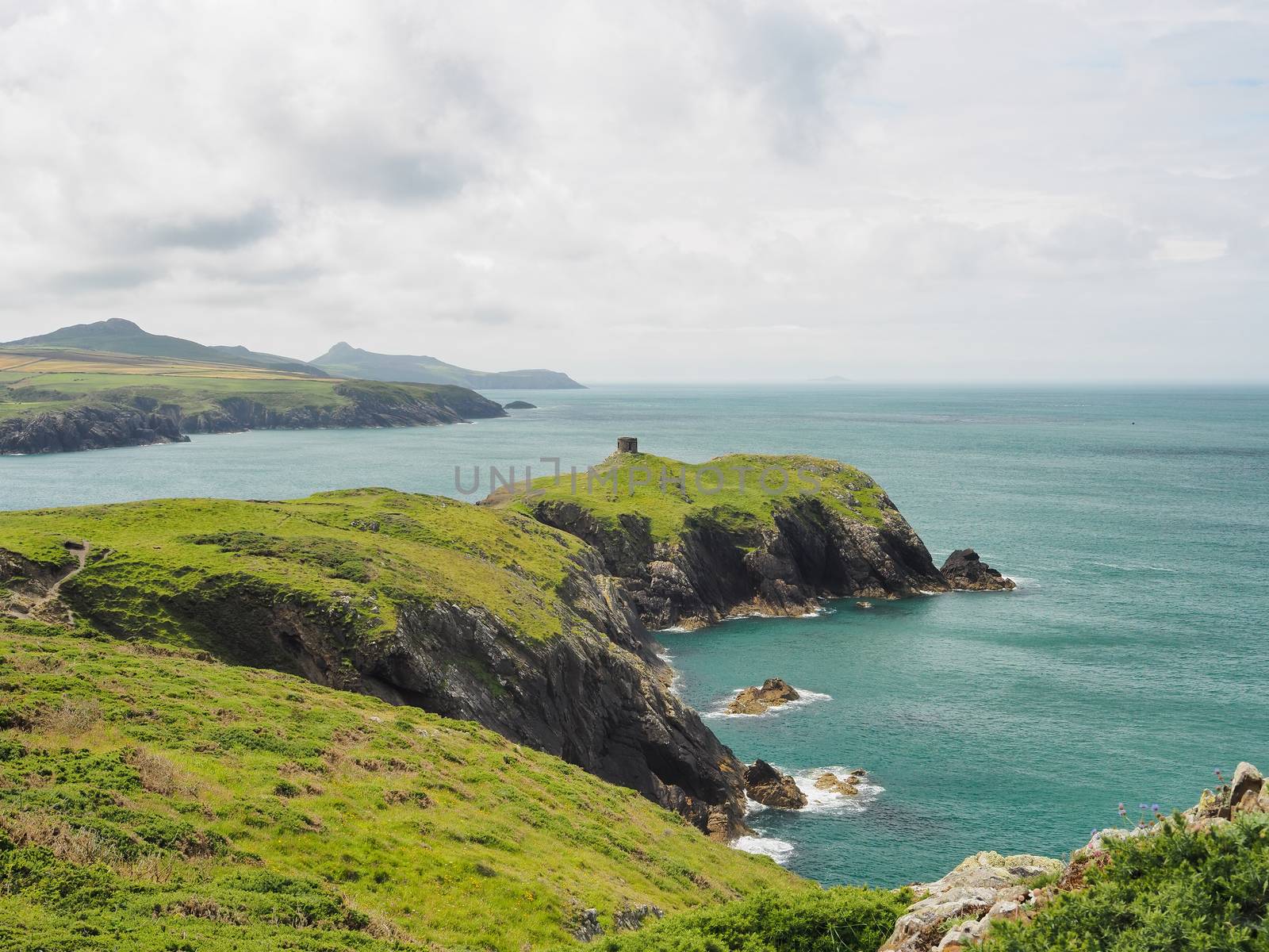 View from cliff top near Abereiddy of round stone tower, Pembrokeshire, Wales by PhilHarland