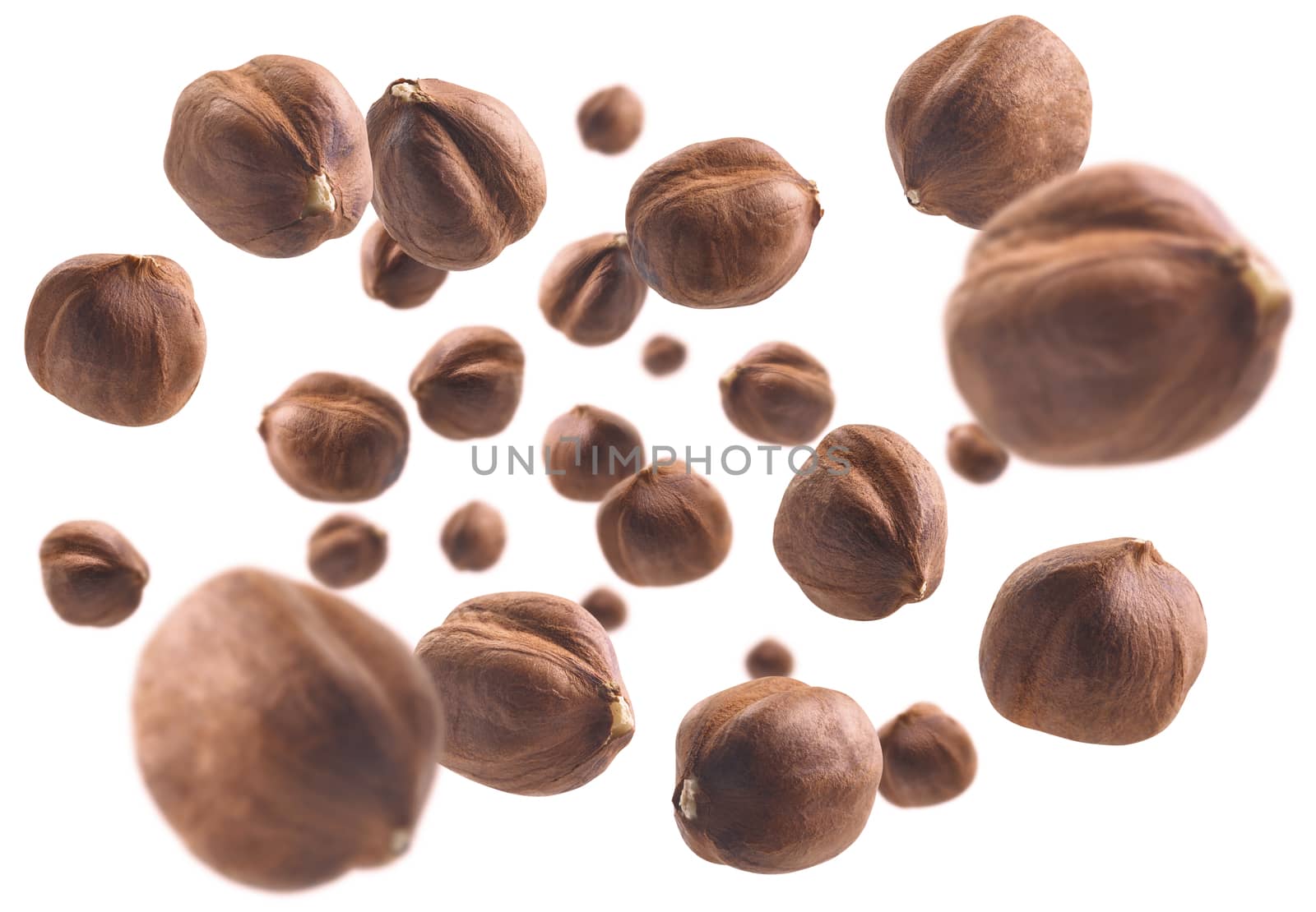 Peeled hazelnut levitates on a white background.