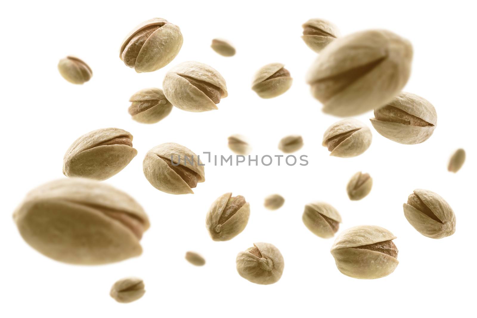 Salted pistachios levitate on a white background.