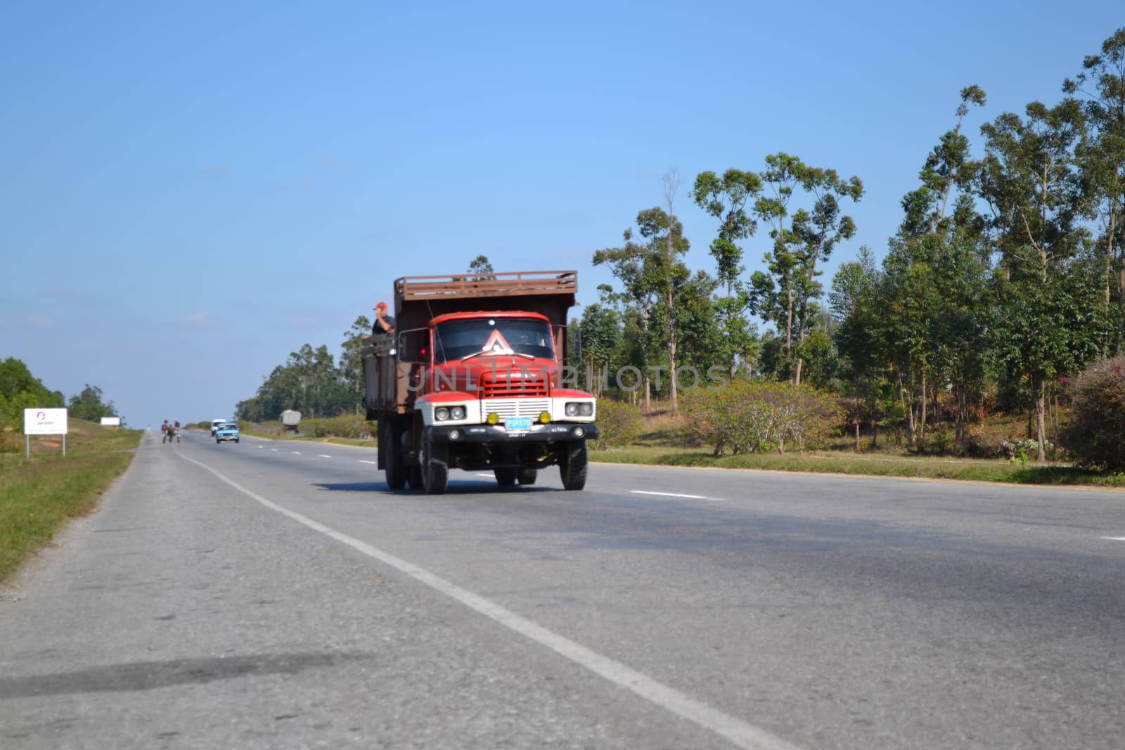 Vinales, Cuba, March 2011: Cuban old timer truck on the road with traffic in the blurred distance