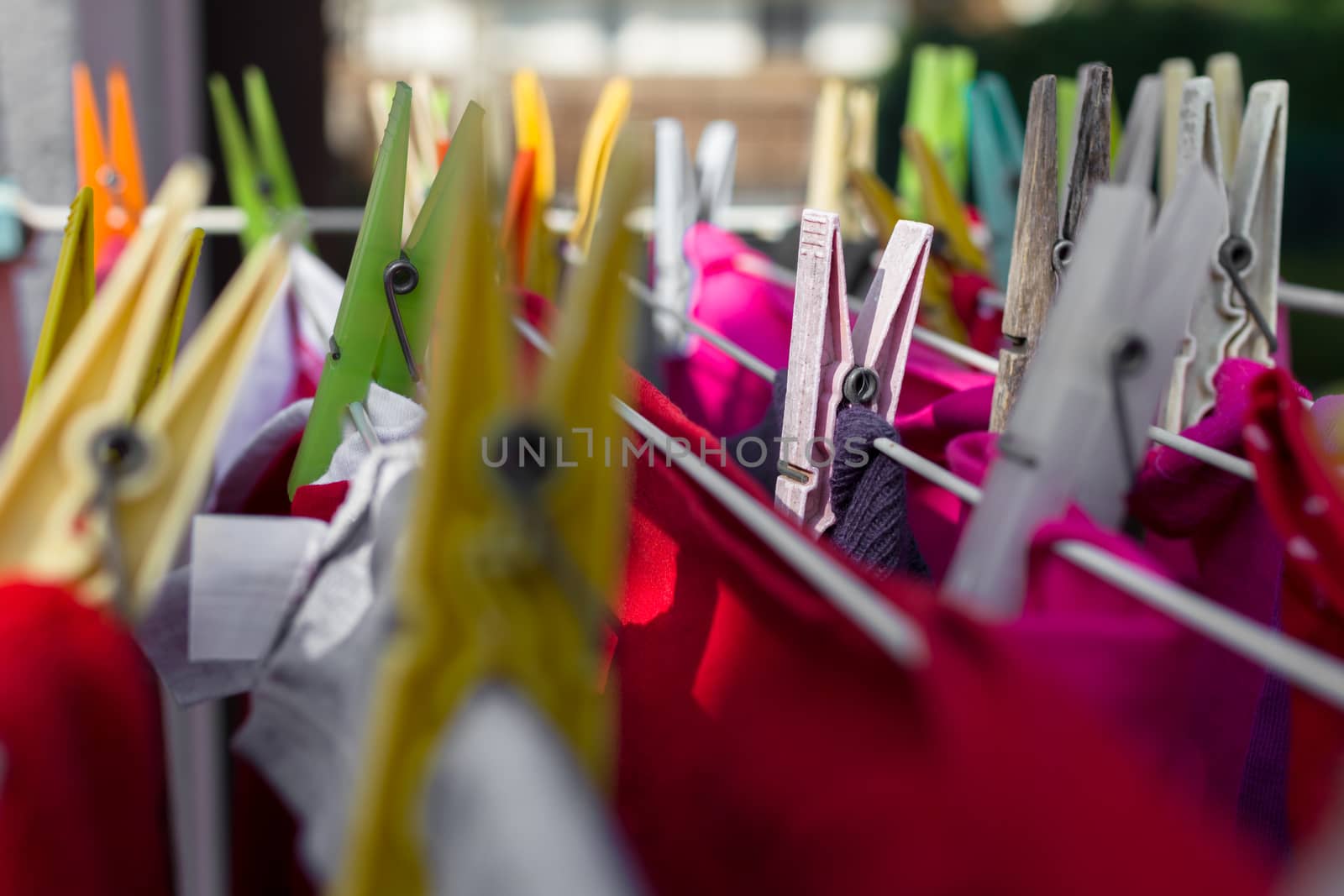 Extreme close-up of colorful clothespins, with blurred background.