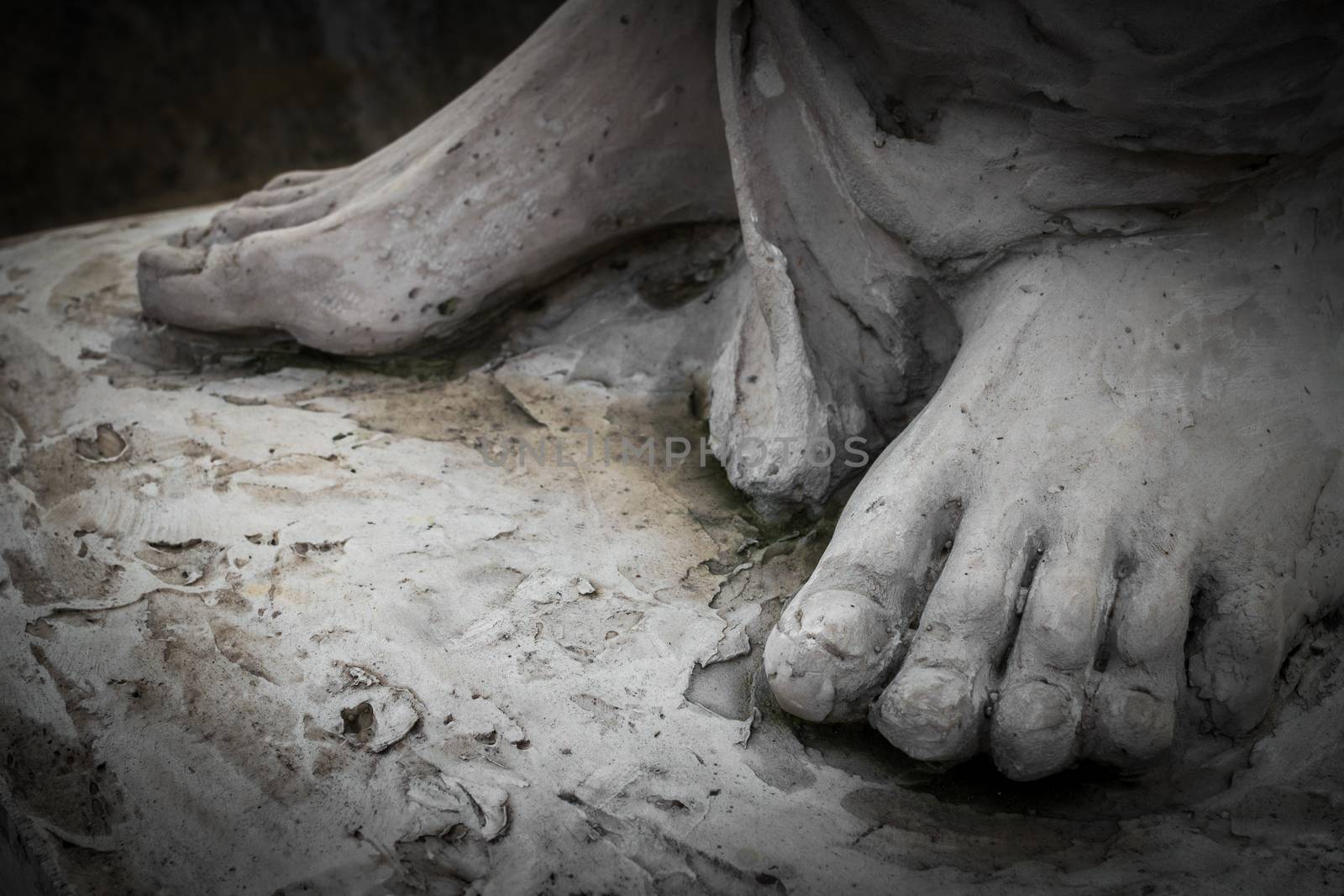 Detail of a marble statue, depicting the foot of the suffering Christ