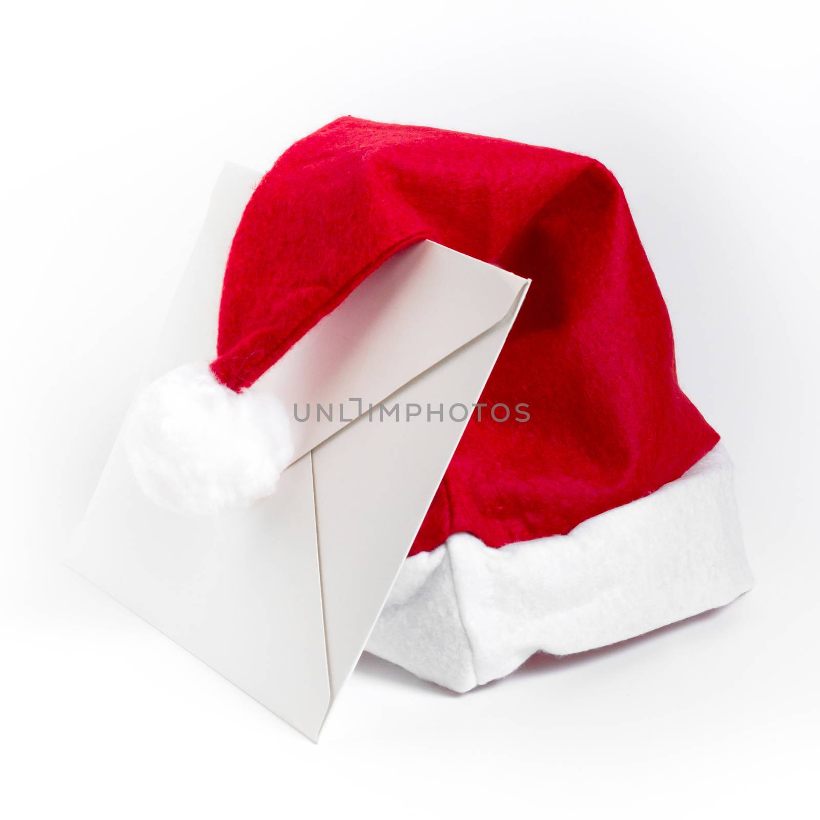 White letter and Santa Claus hat, isolated on white background.