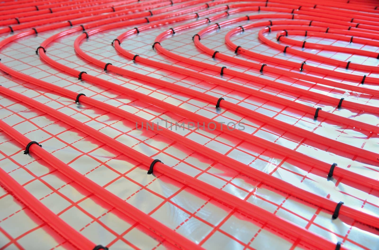 Close-up of water underfloor heating pipes on the silver reflective foil.