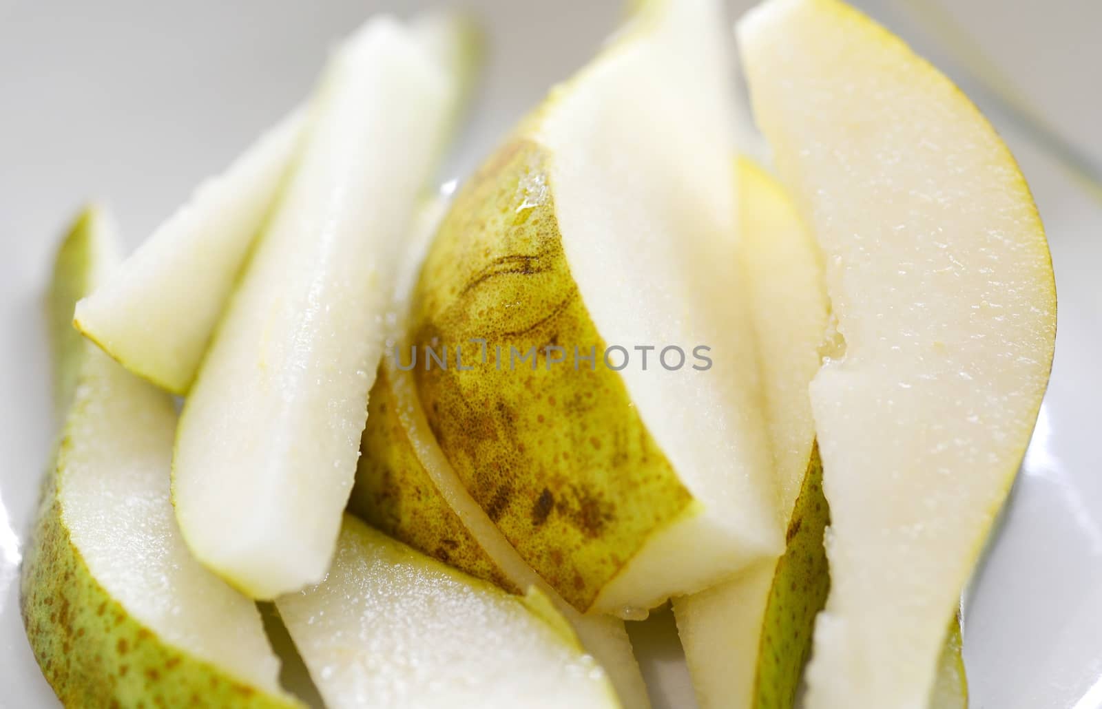 Close-up of the Fresh Pear Slices on the White Plate.