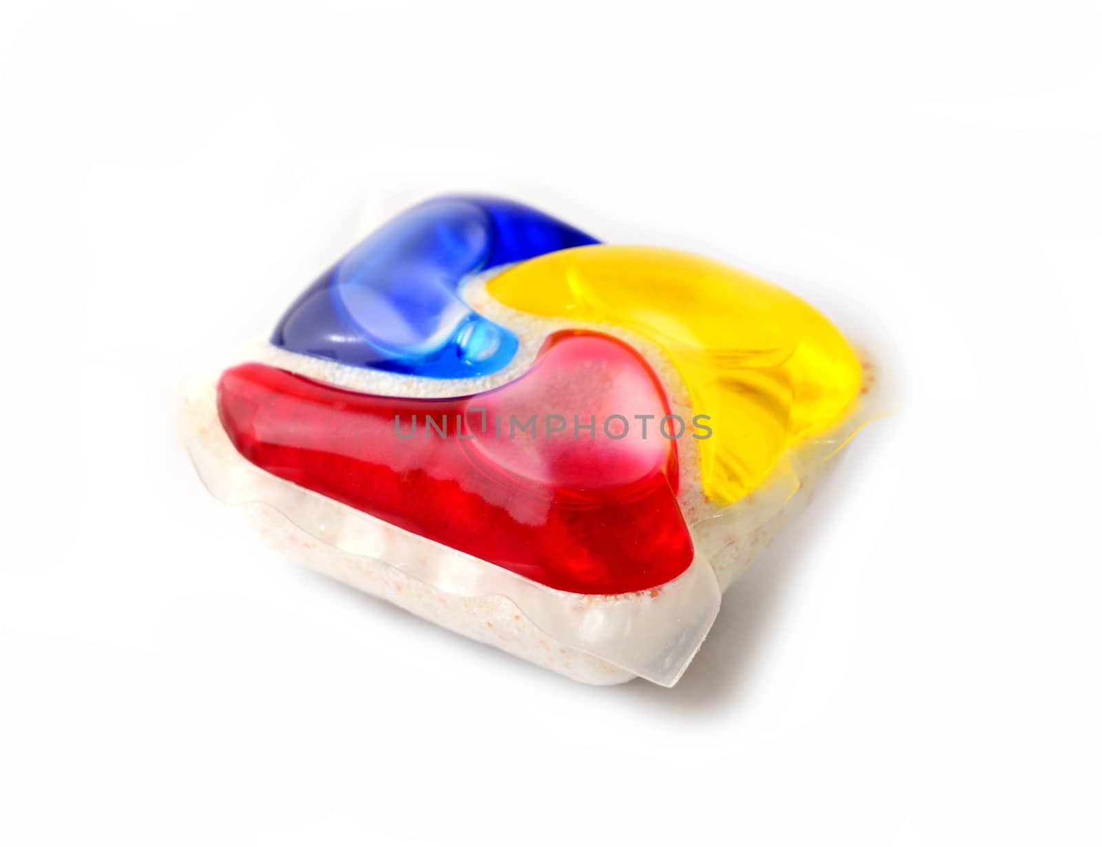 Closeup of modern multicolor gel dishwasher tablet over white background.