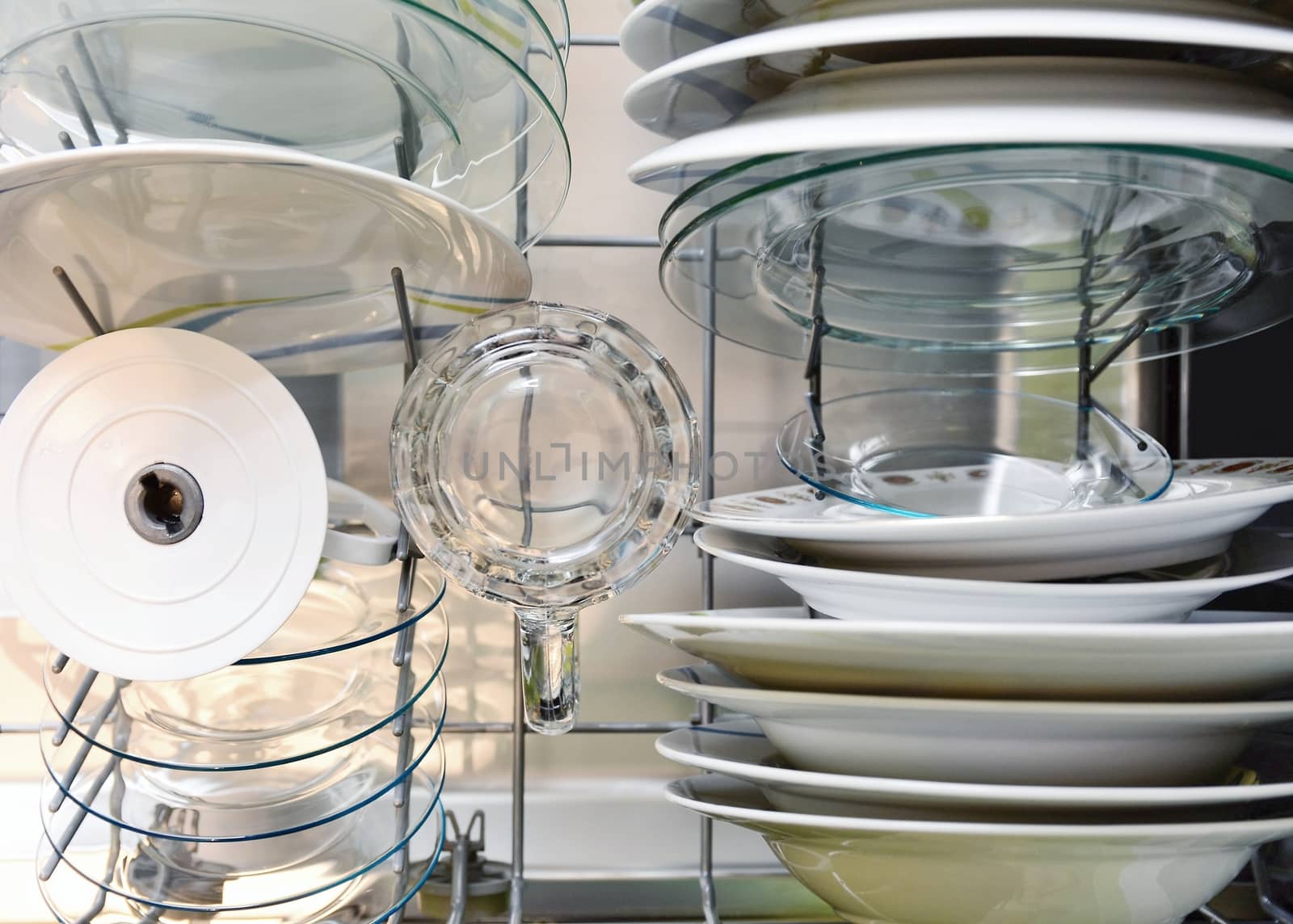 Cleaned dishes in dishwasher rack top view. by hamik