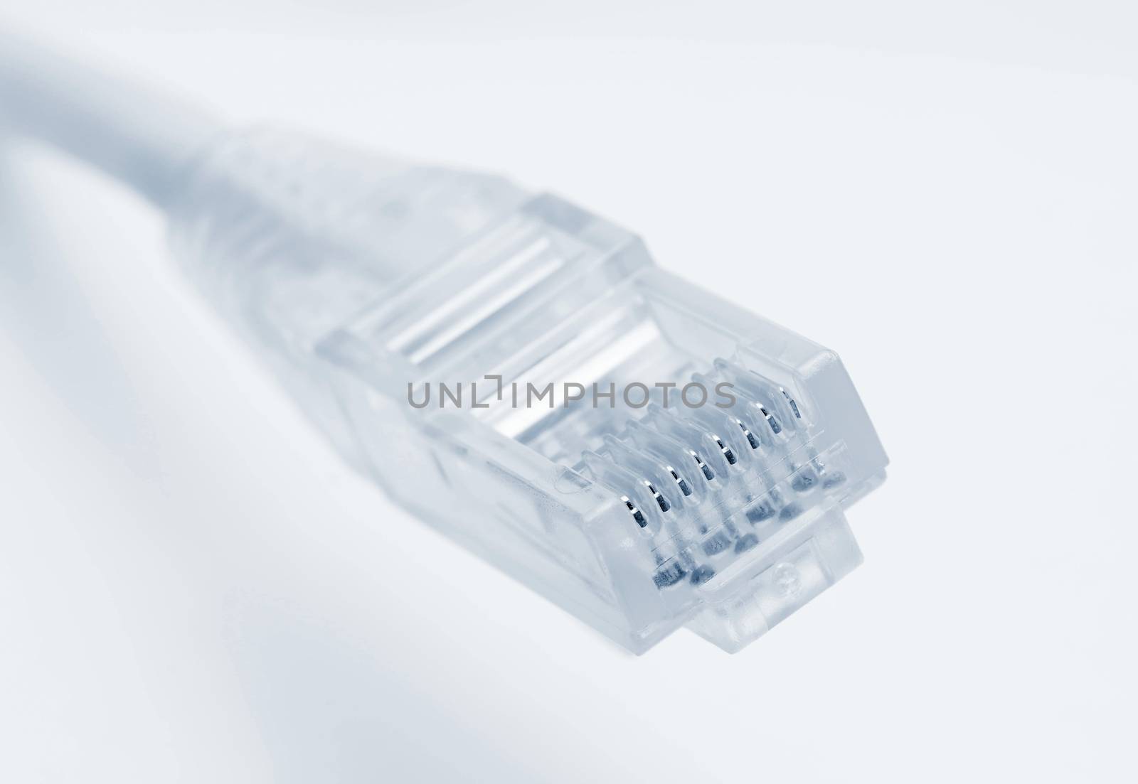 Closeup of rj45 connector of patch cable for LAN connection over white background.