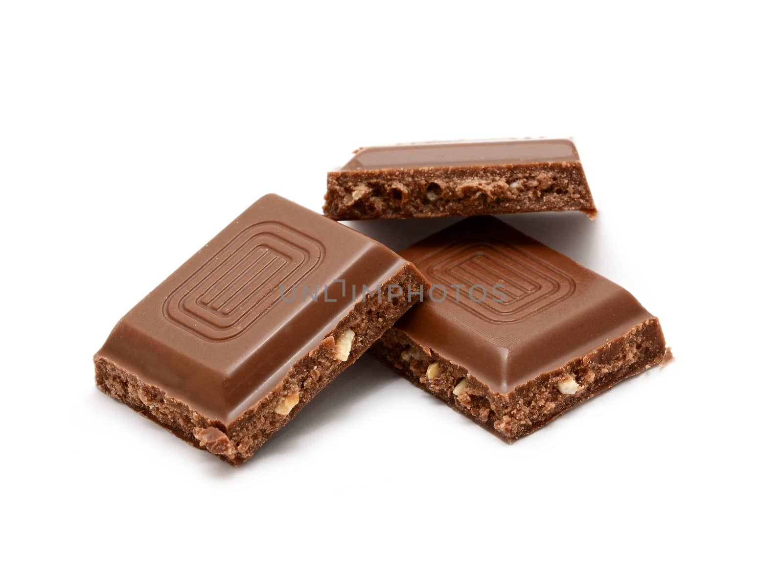 Nut chocolate squares over white background. by hamik