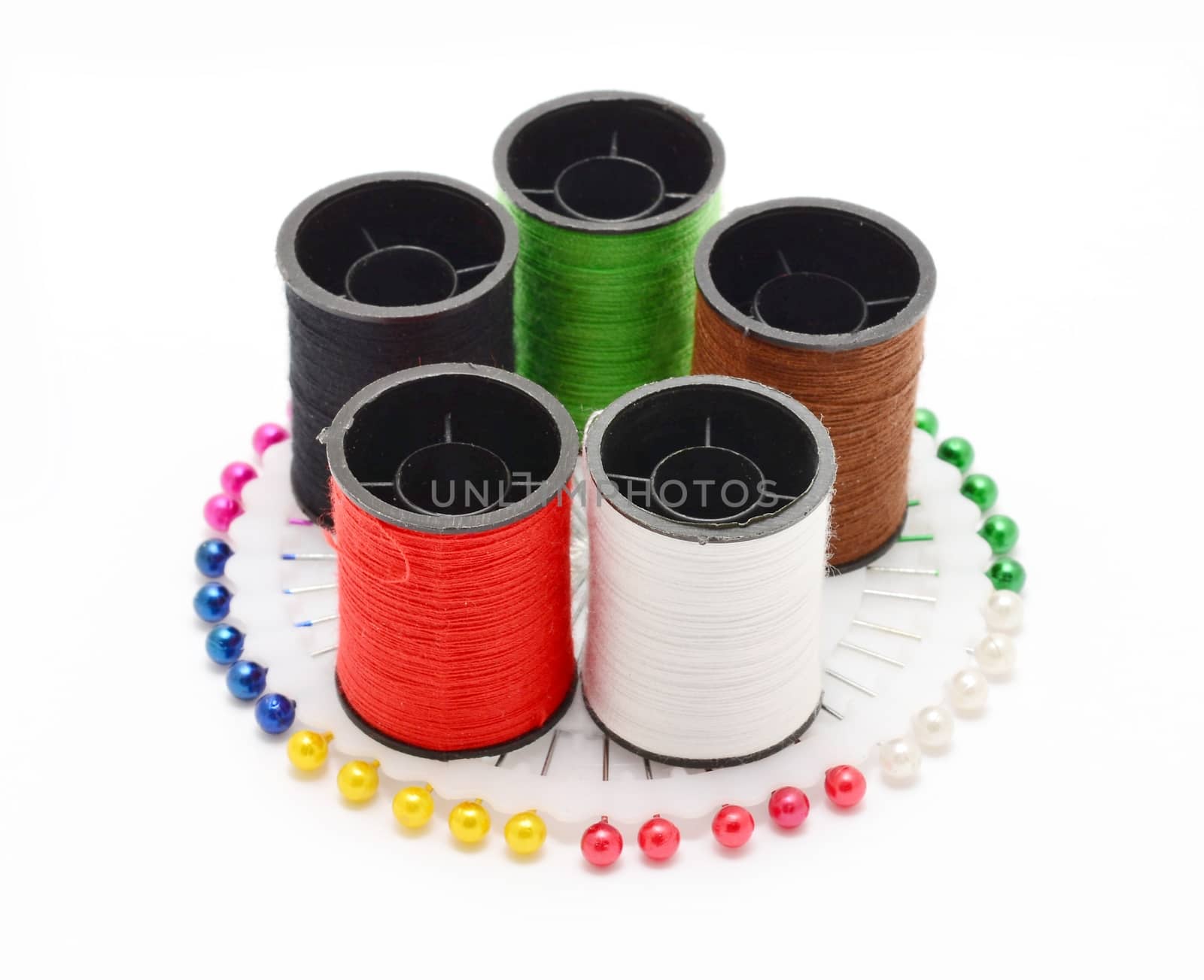 Set of color sewing threads on sewing pins wheel. by hamik