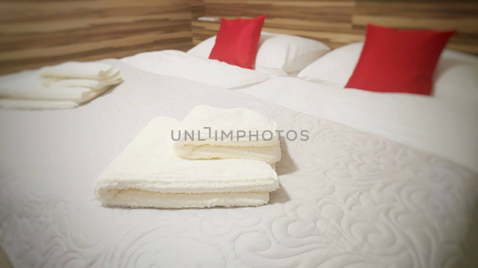 Folded towels on the bed by hamik