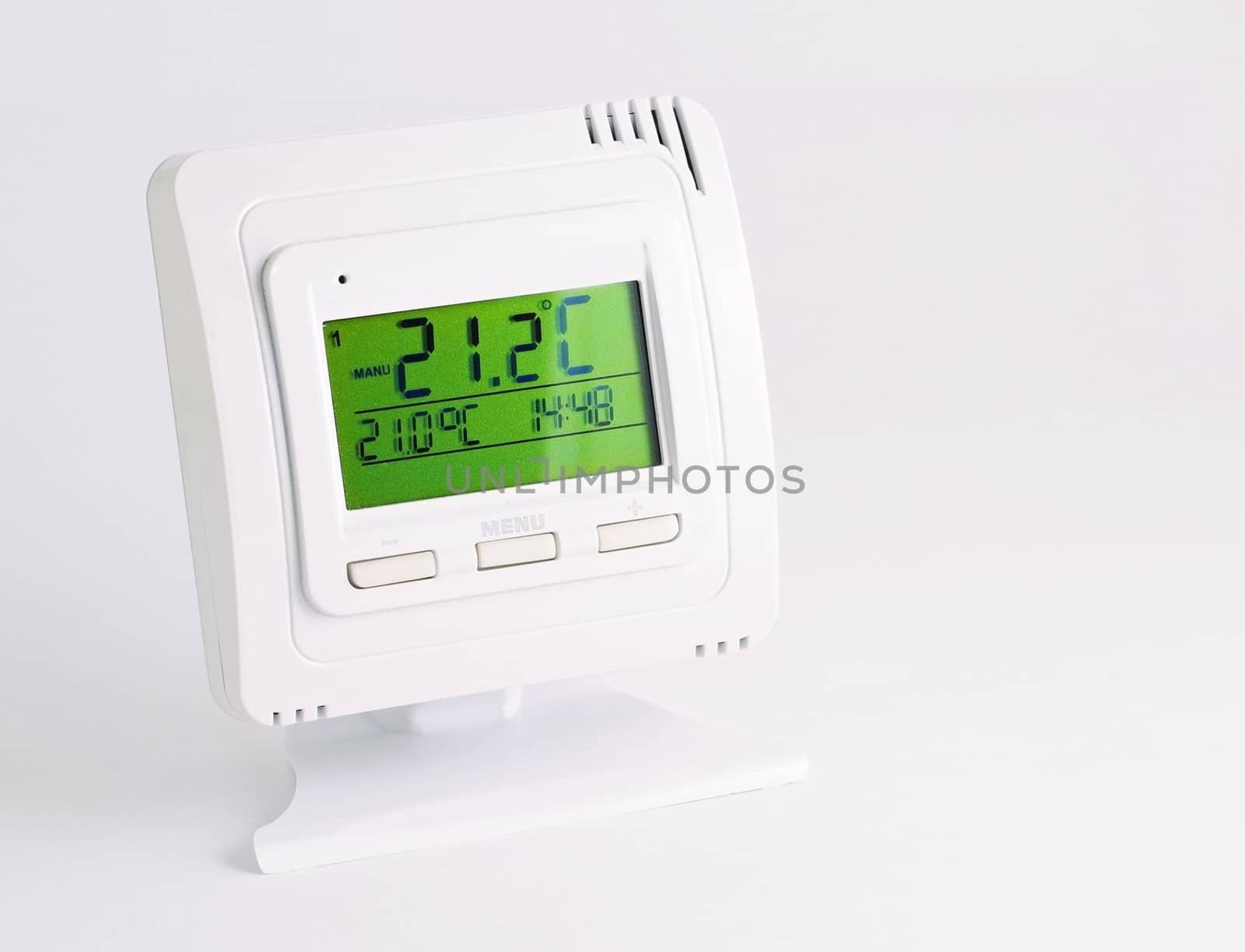 Remote home interior thermostat controller over white background.