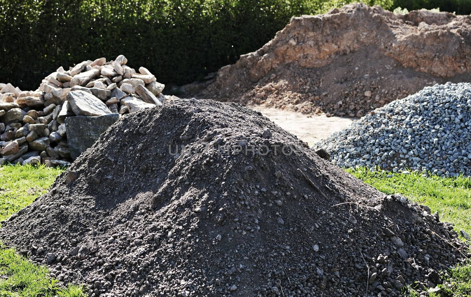 Outside storage place with heaps of gravel, stones and soil.