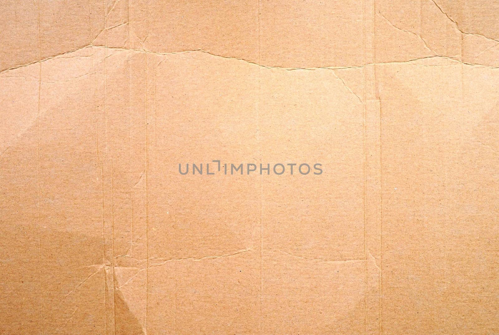 Full frame texture of blank crumpled and wrinkled brown cardboard background.
