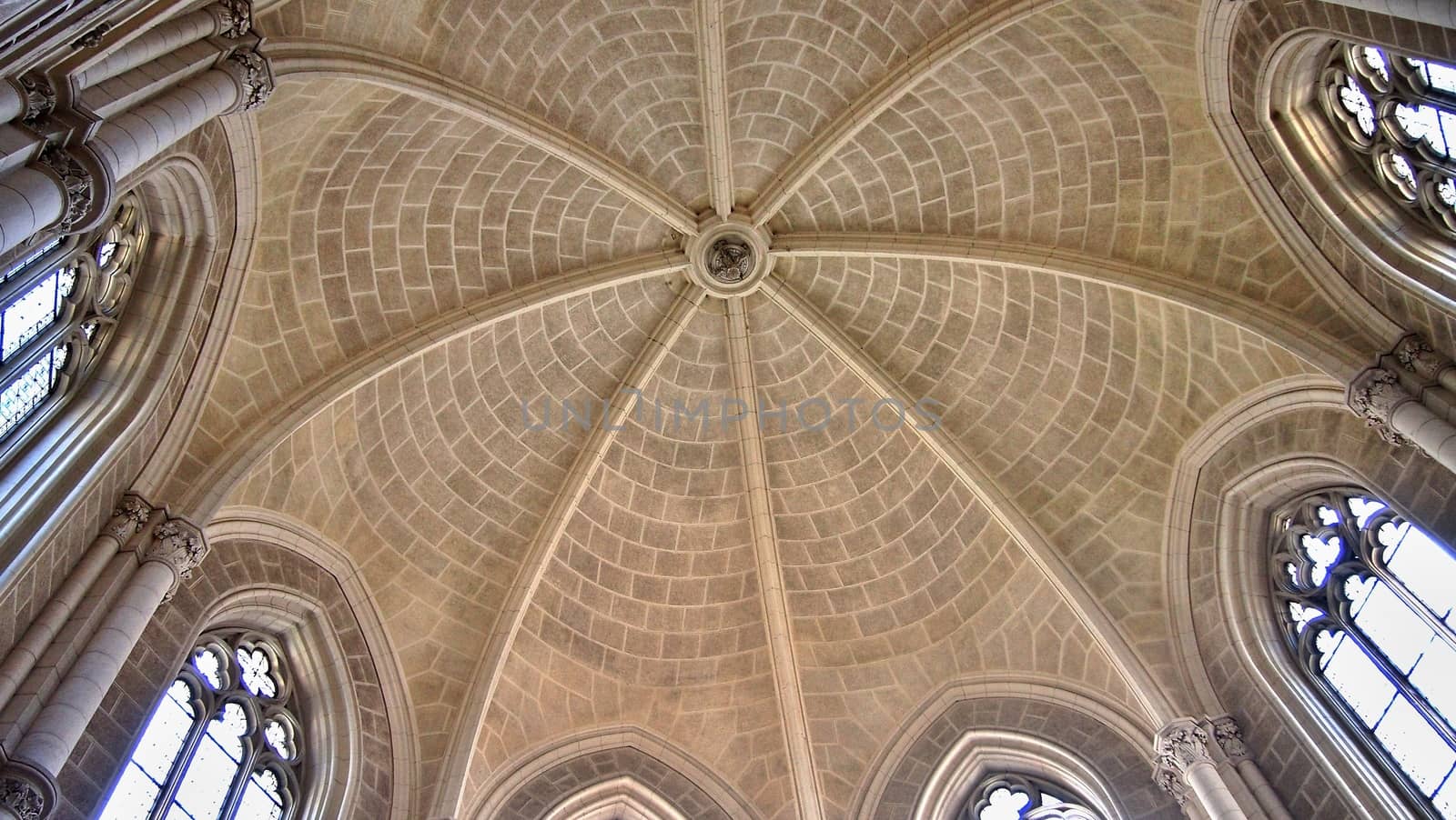 Interior look up view of church mosaic tiled dome with windows.