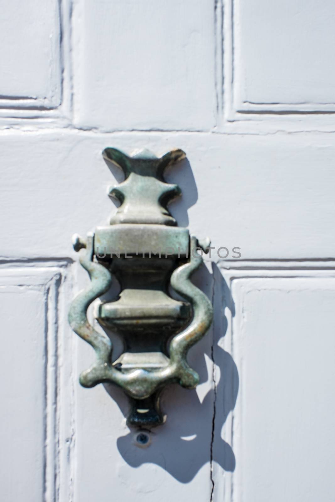 brass door knockers on cottage doors in the Cotswolds UK by paddythegolfer