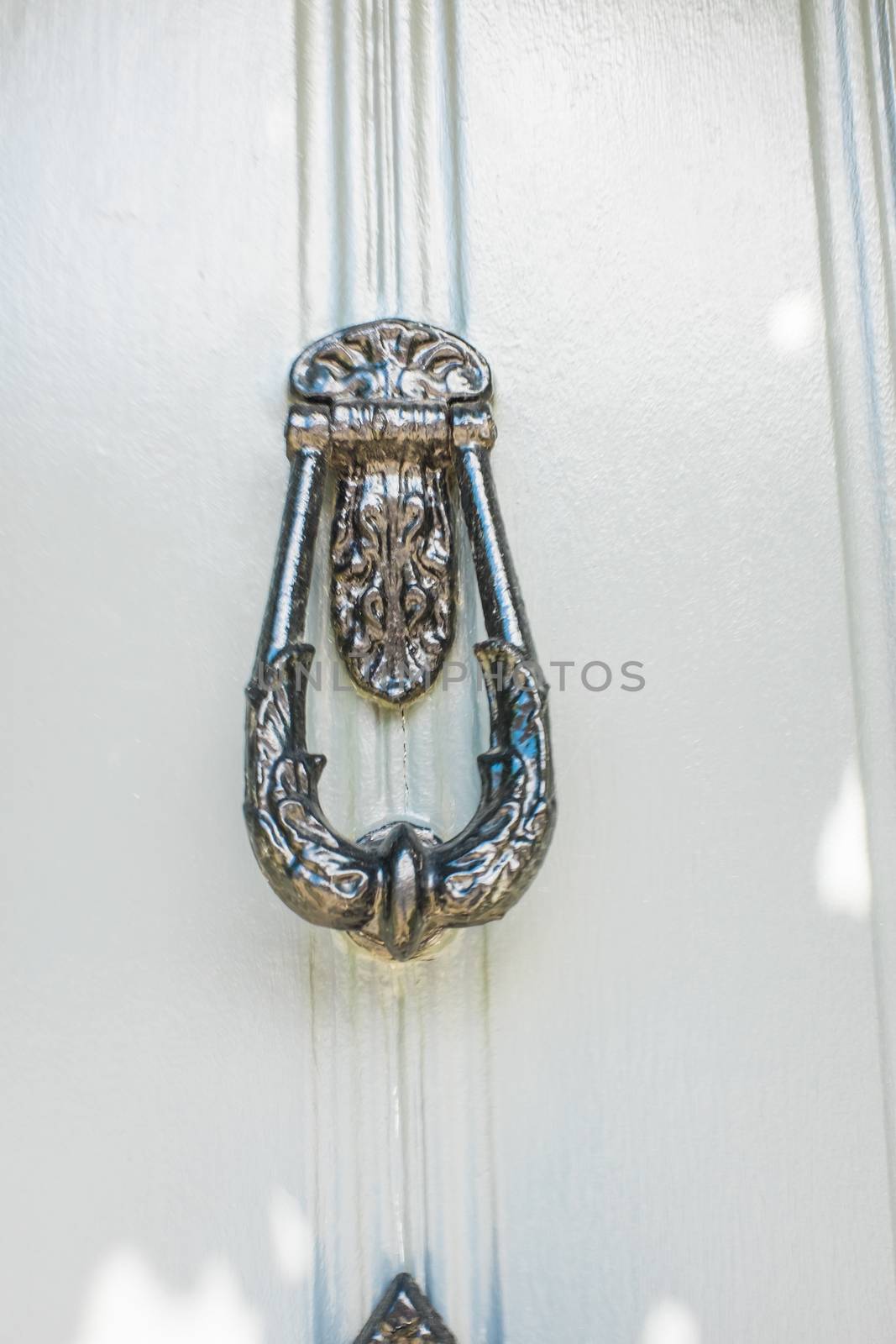 brass door knockers on cottage doors in the Cotswolds UK by paddythegolfer