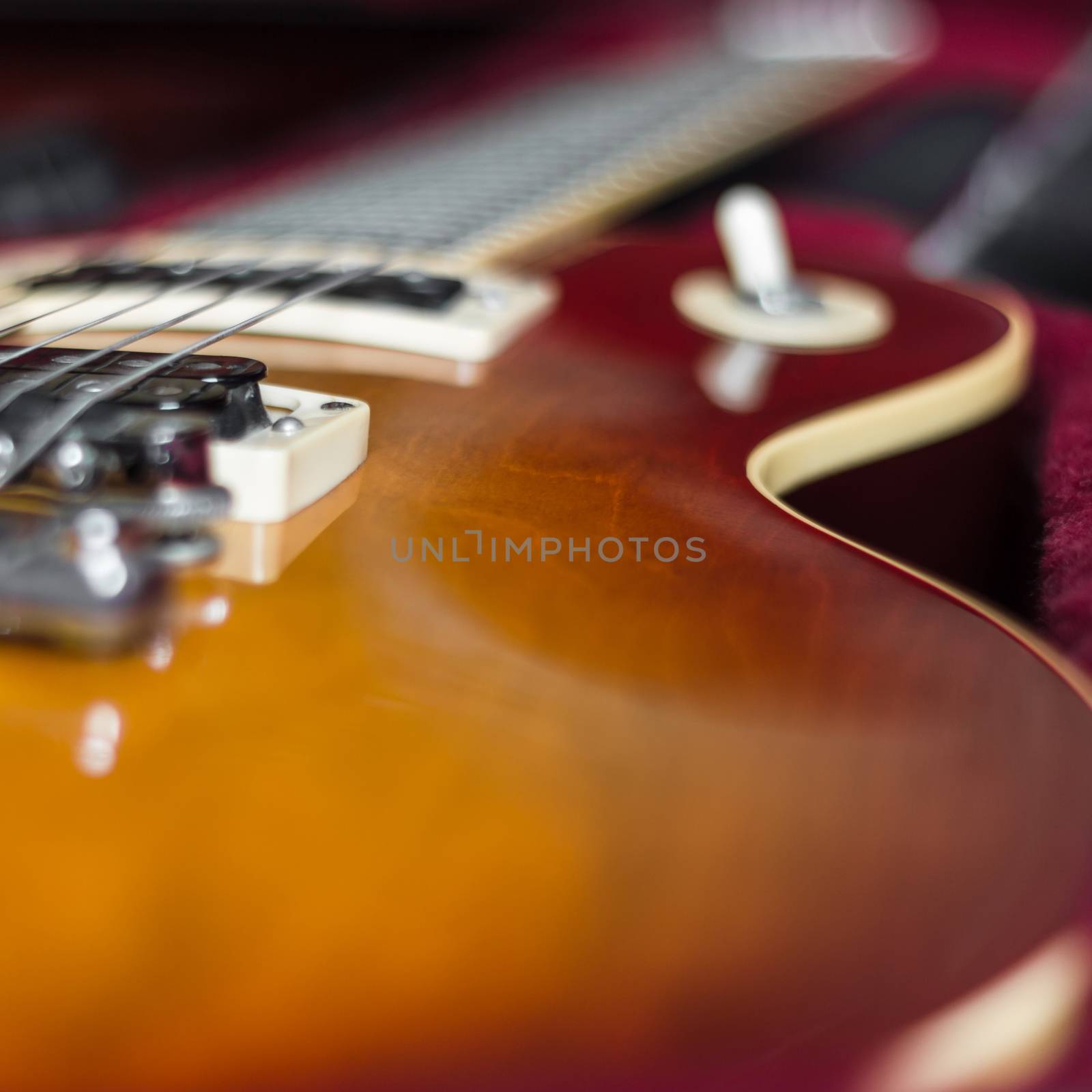 Extreme close-up of an electric guitar in its carry case.