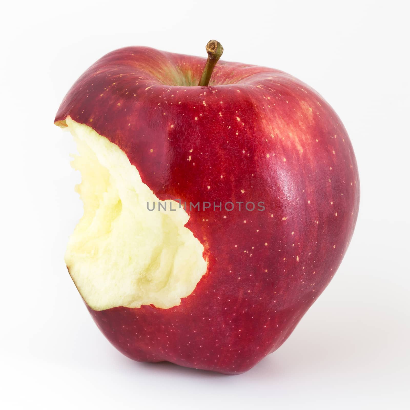 Close-up of an bitten apple on white background and copy space.