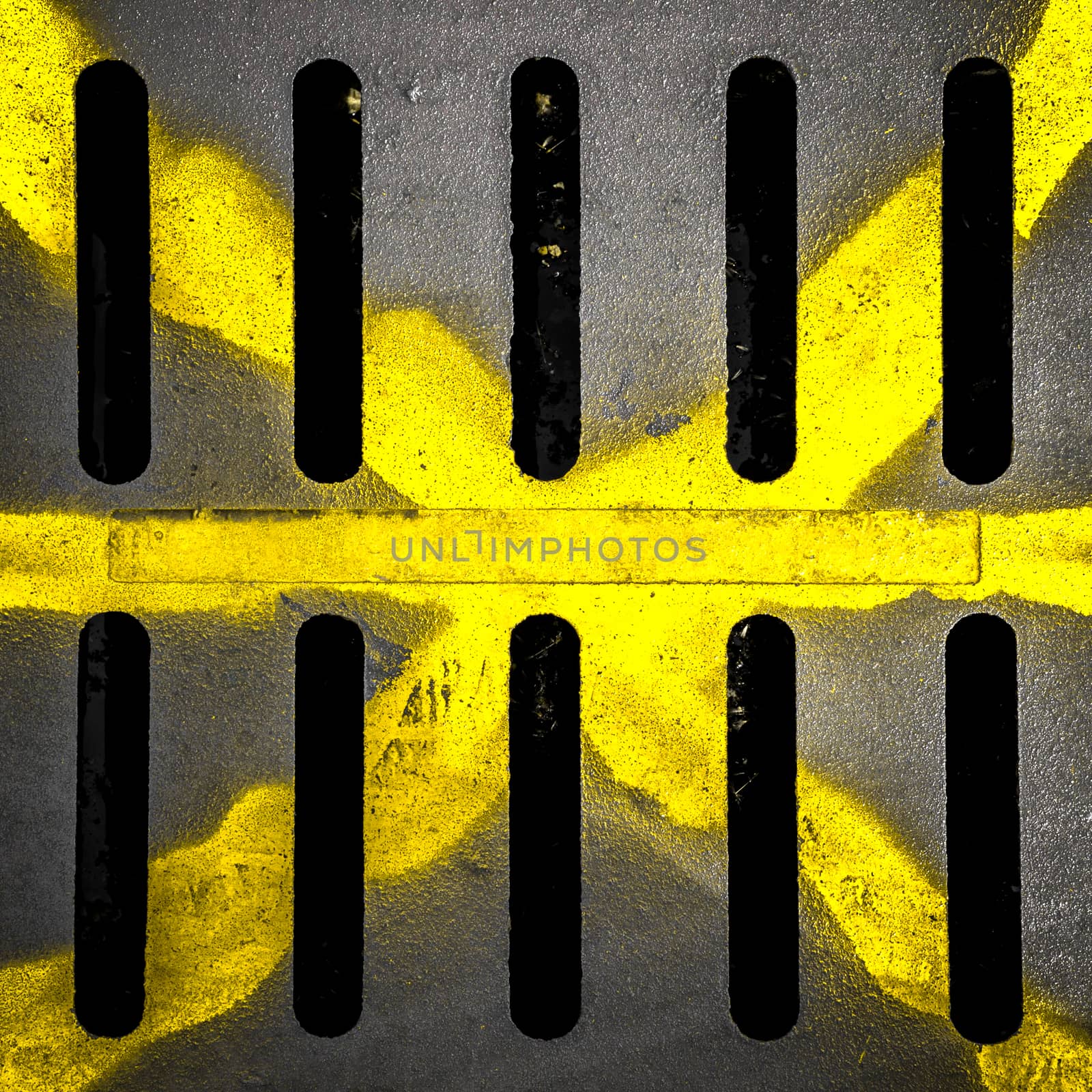 Detail of a manhole with yellow X drawn with paint spay.