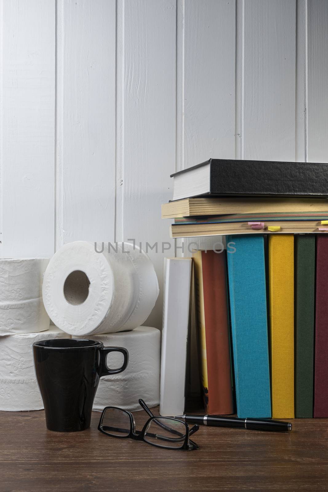 some toilet paper rolls and some books on the table 