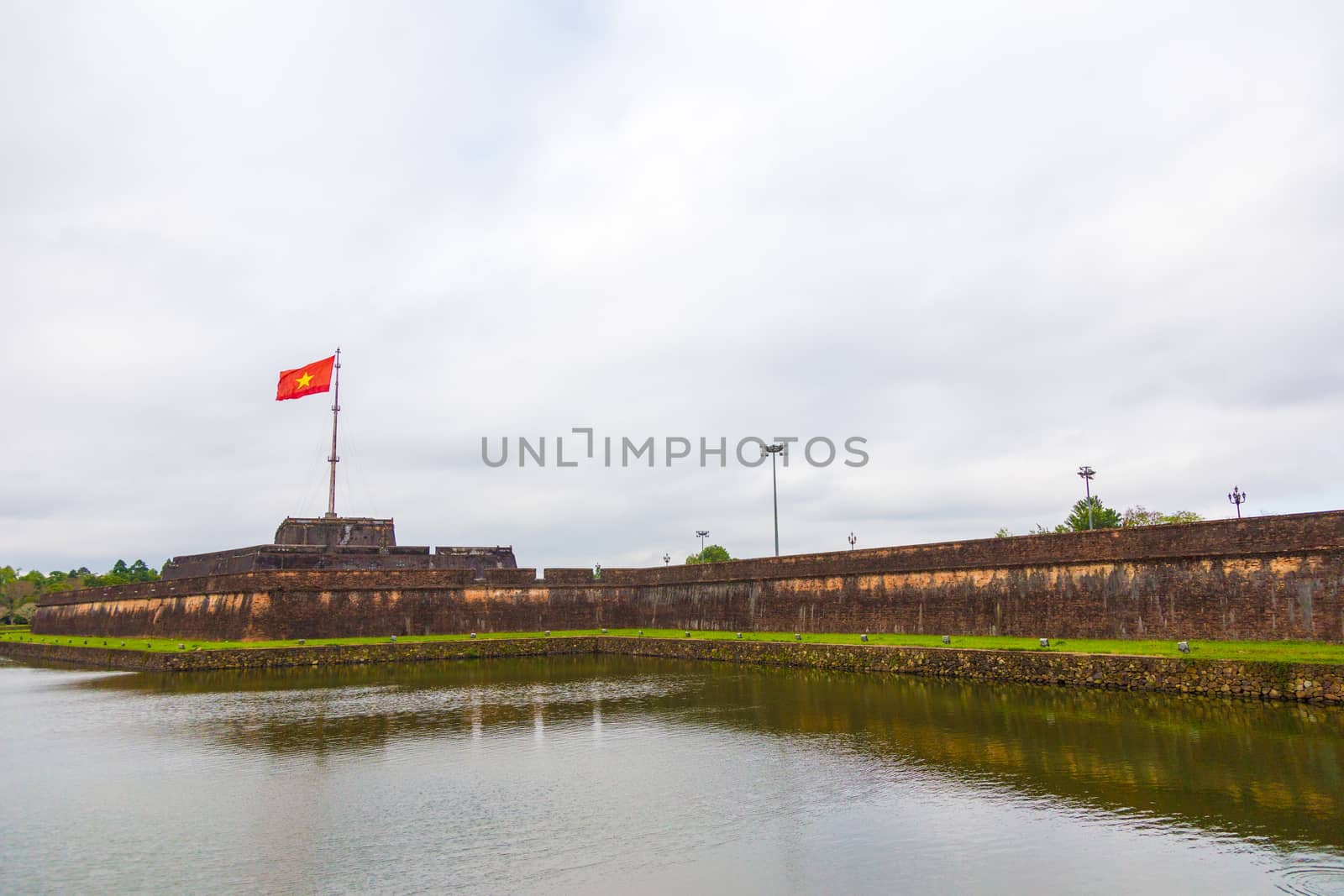 Hue, old capital of Vietnam from 1802 to 1945.. Architecture and details of buildings. A major attraction is its vast, 19th-century Dai Noi Citadel, surrounded by a moat and thick stone walls. It encompasses the Imperial City, with palaces and shrines. High quality photo