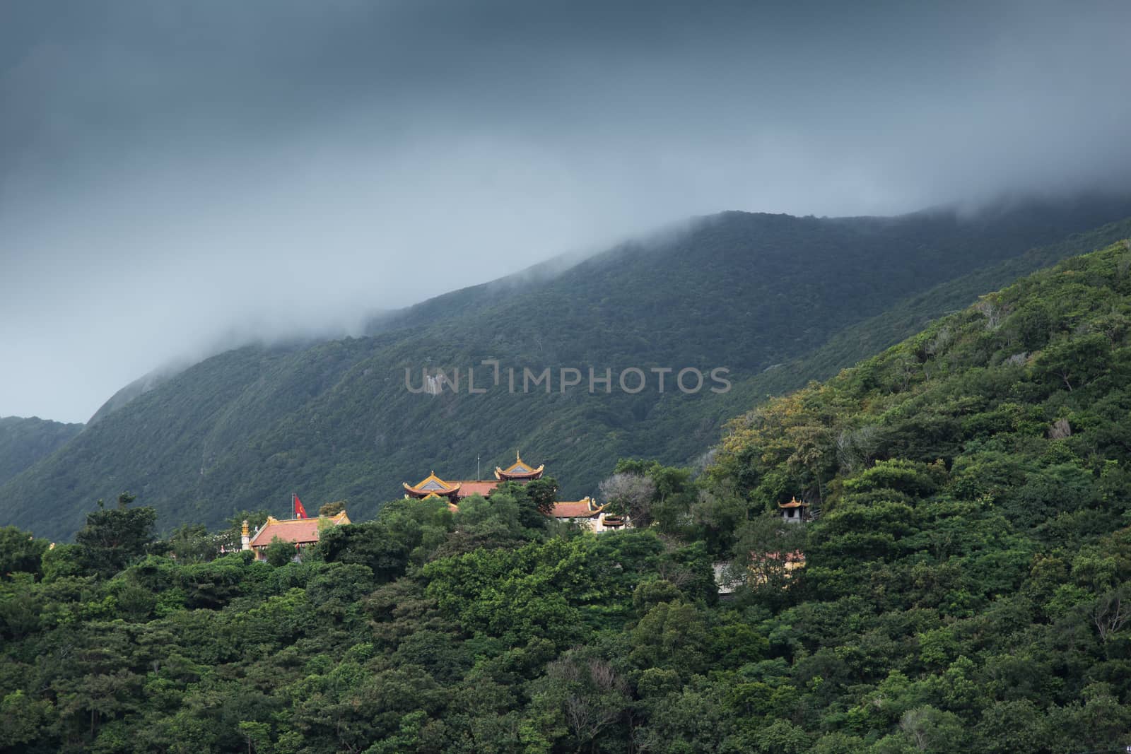 Con Dau, also known as Con Son, island from south east coast Vietnam, Van Son Pagoda in mountains with storm clouds also famous for tiger prisons used by French and Americans. High quality photo