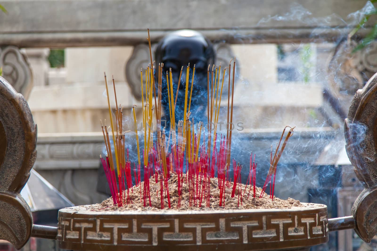 Incense burning in shrine to Ho Chi Minh. Incense is a part of Vietnamese life and will be found in homes and religious places. Called huong or nhang and sticks are usually burned in odd numbers.High quality photo