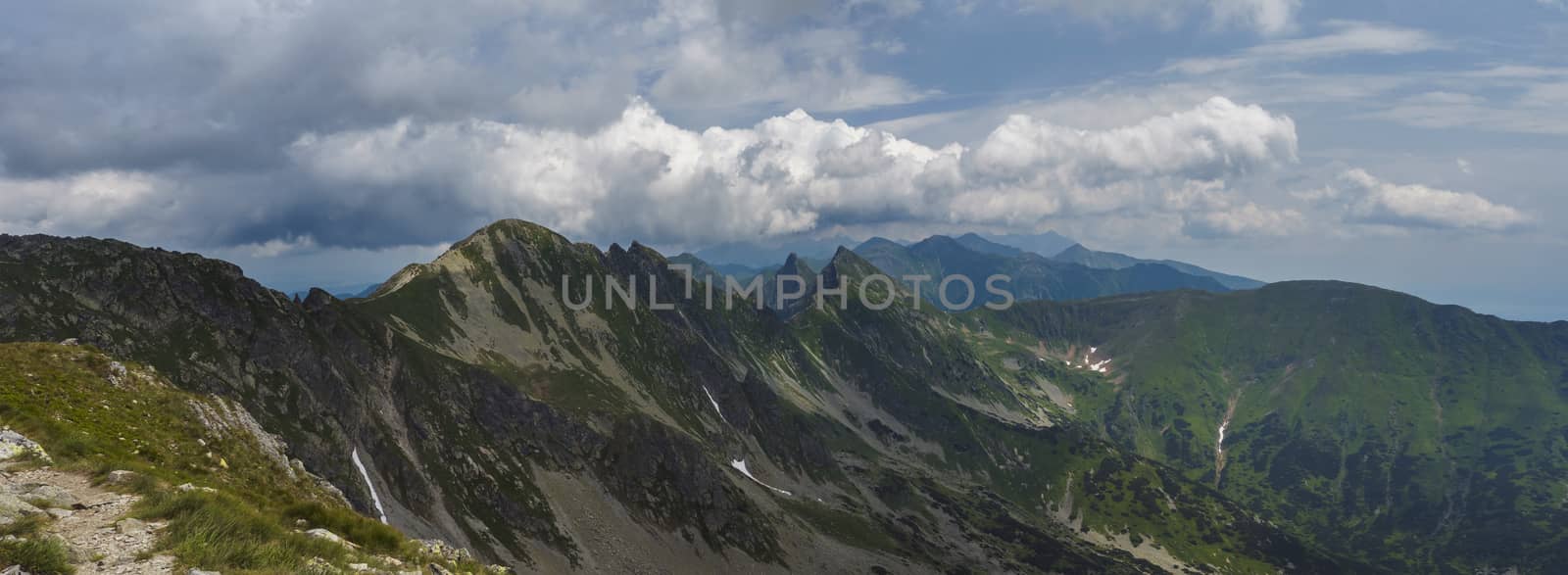 Panoramic view from Banikov peak on Western Tatra mountains or Rohace panorama. Sharp green mountains - ostry rohac, placlive and volovec with hiking trail on ridge. Summer blue sky white clouds. by Henkeova