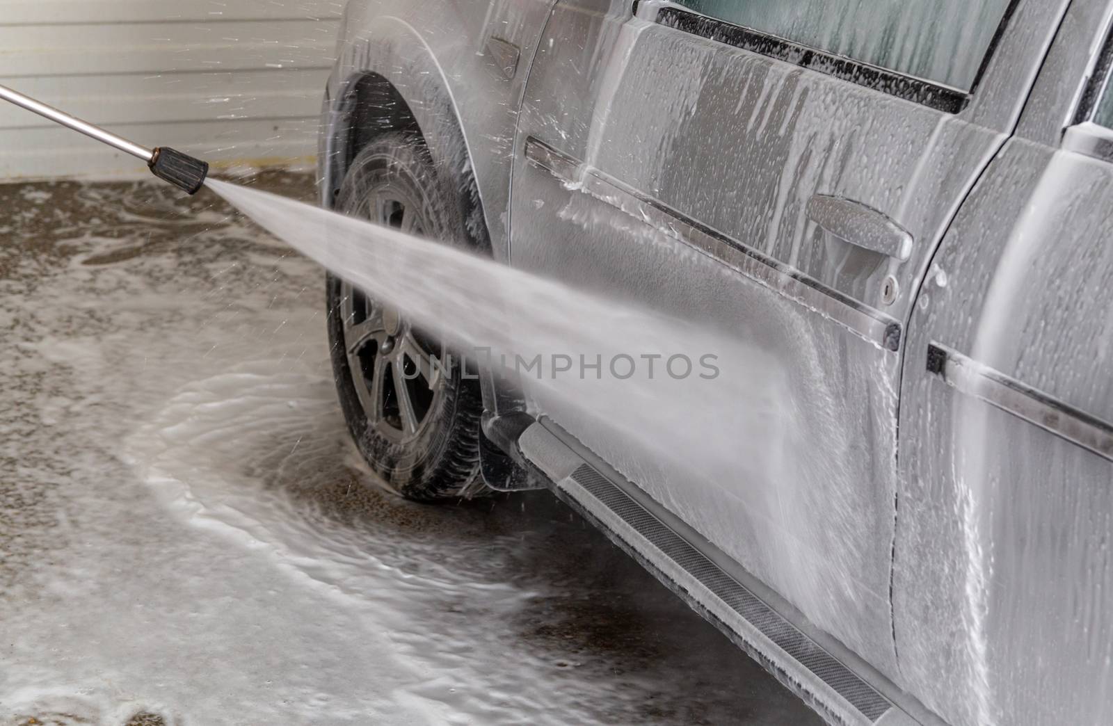 a closeup view of process of indoor wet car washing.