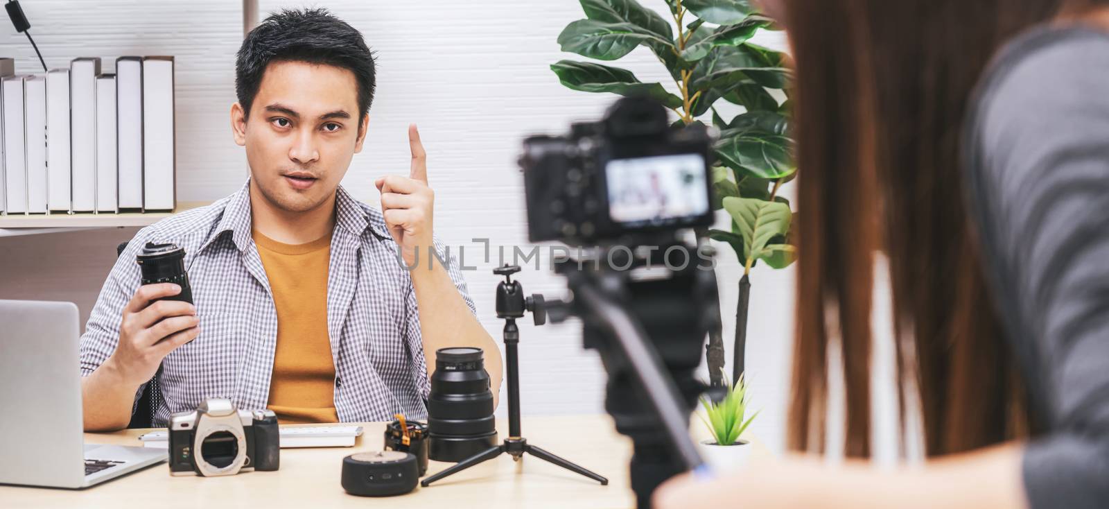 Banner Camera taking video and live with laptop of Asian Vlogger man satisfied the camera lens each media, sharing knowledge to audience via camera by social media channel,vlog and Influencer concept