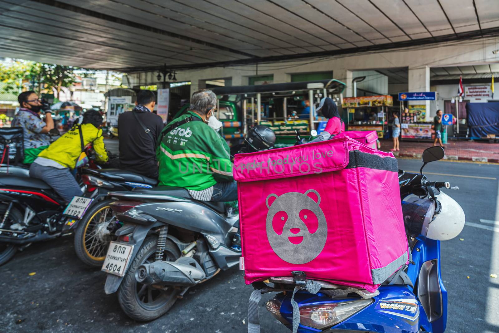 BANGKOK, THAILAND - APRIL 2020 : Various food delivery box on the motorcycles include Food Panda, Grab and Get food at Food delivery service point on April 17, 2020, Bangkok,Thailand, Covid outbreak