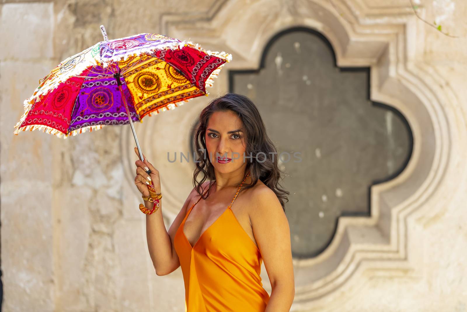 A Lovely Hispanic Brunette Model Poses Outdoors On A Mexican Ranch Holding A Parasol by actionsports