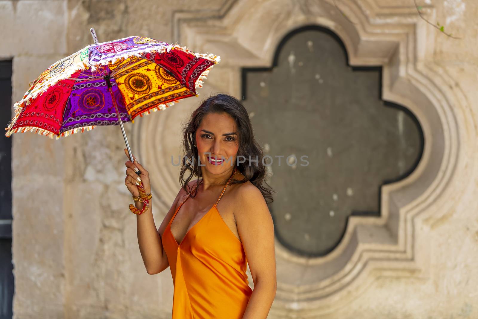 A Lovely Hispanic Brunette Model Poses Outdoors On A Mexican Ranch Holding A Parasol by actionsports