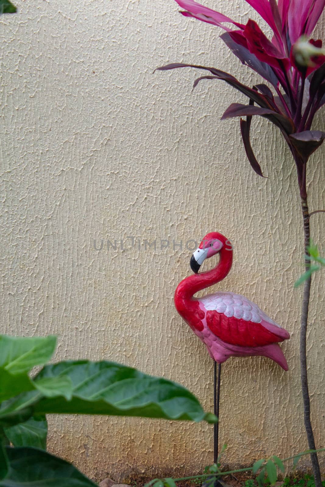 Sculpture of a flamingo ornamenting a garden by etcho