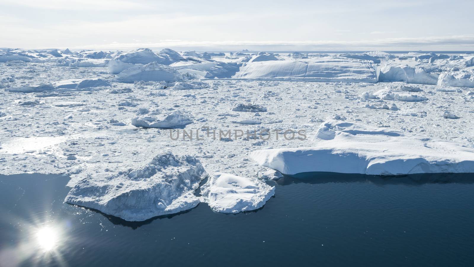 Iceberg aerial drone image - Global warming and climate change concept. Giant icebergs in Disko Bay on greenland in Ilulissat icefjord from melting glacier Sermeq Kujalleq Glacier, Jakobhavns Glacier by Maridav
