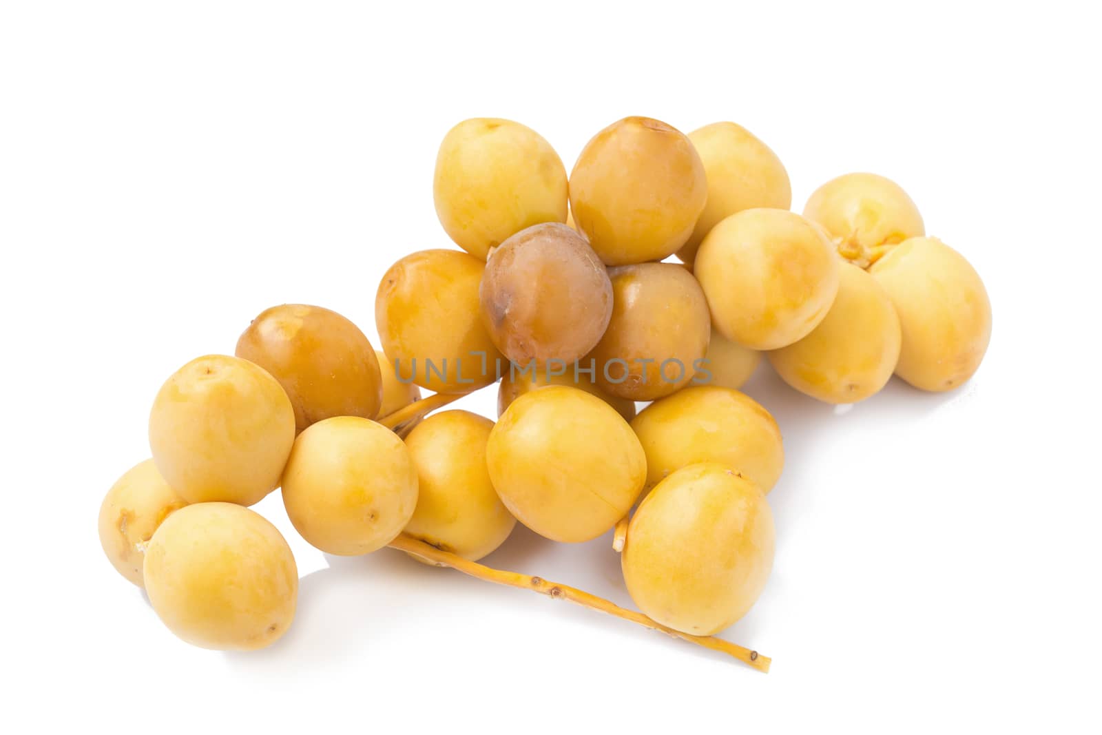 yellow raw dates isolated on white background by kaiskynet