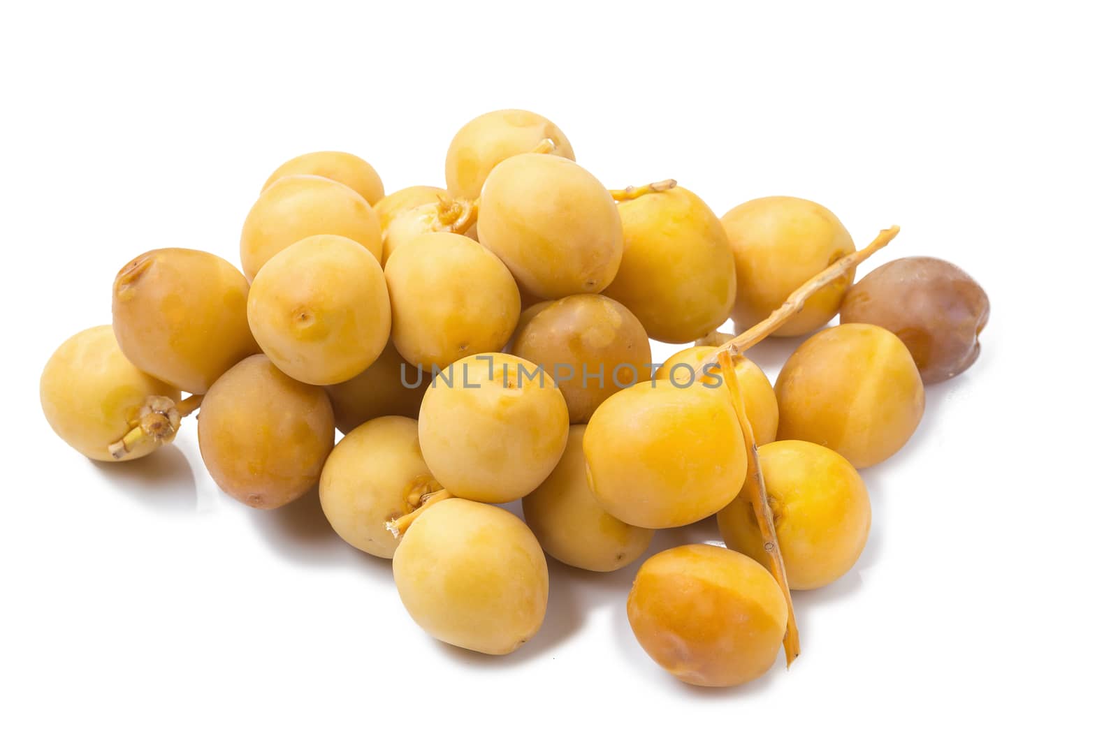 yellow raw dates isolated on white background by kaiskynet