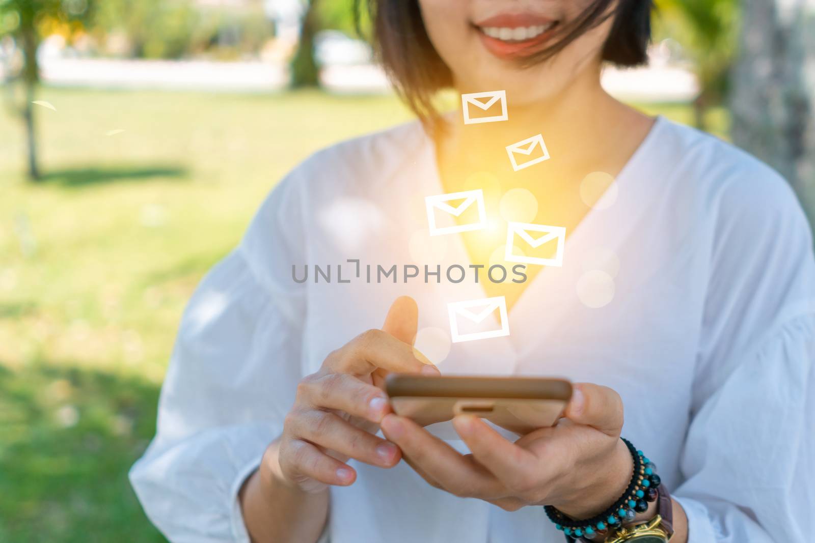 Woman hand using smartphone to send and recieve email for business. by Suwant