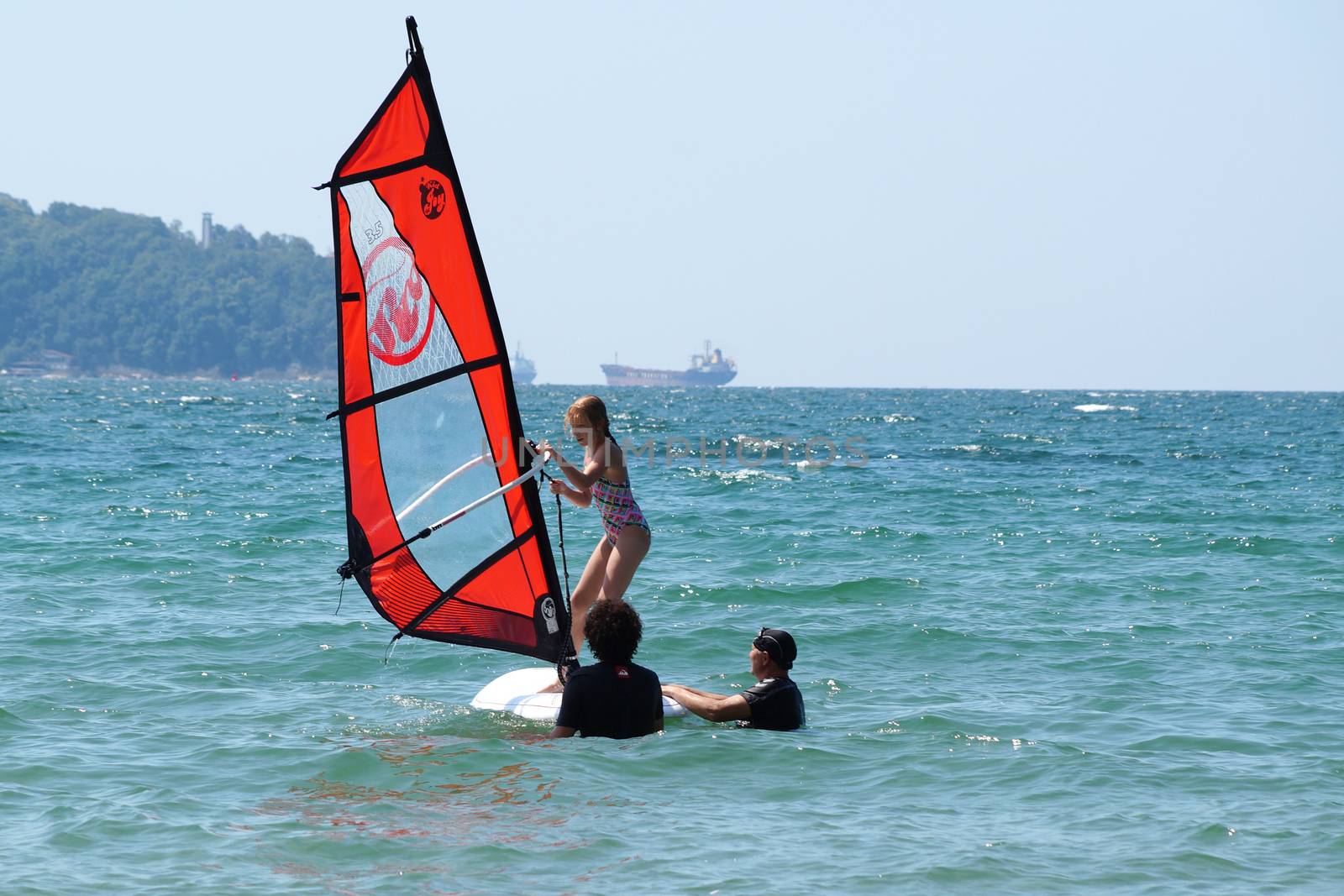 Varna, Bulgaria - July,31,2020: instructors teach the child to ride windsurfing