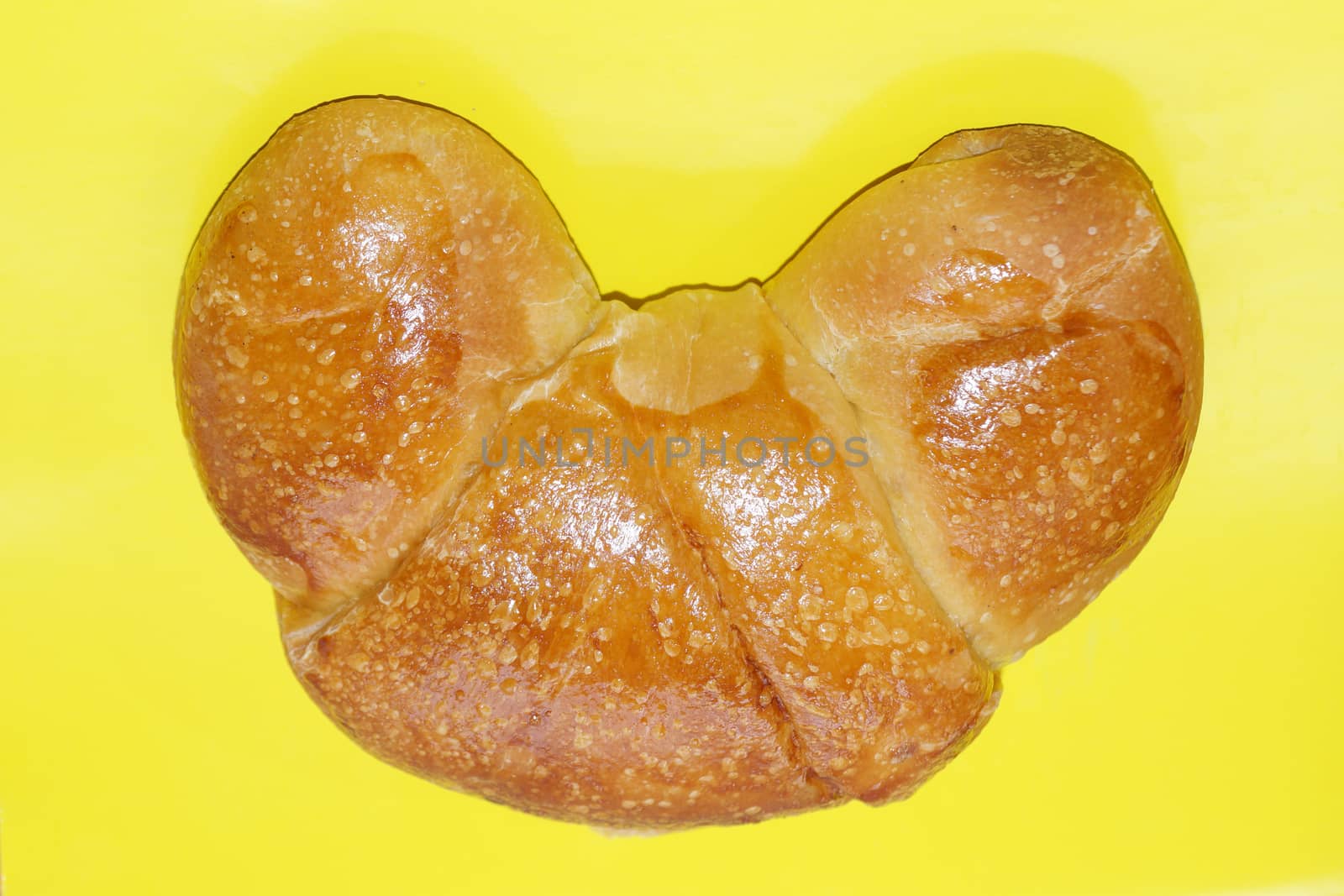 butter french croissant on yellow background close up by Annado