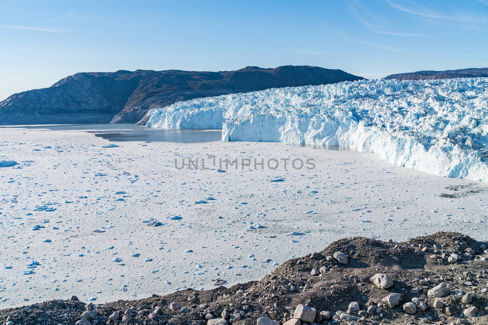 Climate Change Concept. Greenland Glacier heavily affected by Global Warming. Glacier front of Eqi glacier in West Greenland AKA Ilulissat and Jakobshavn Glacier. Produces many of Greenlands icebergs by Maridav