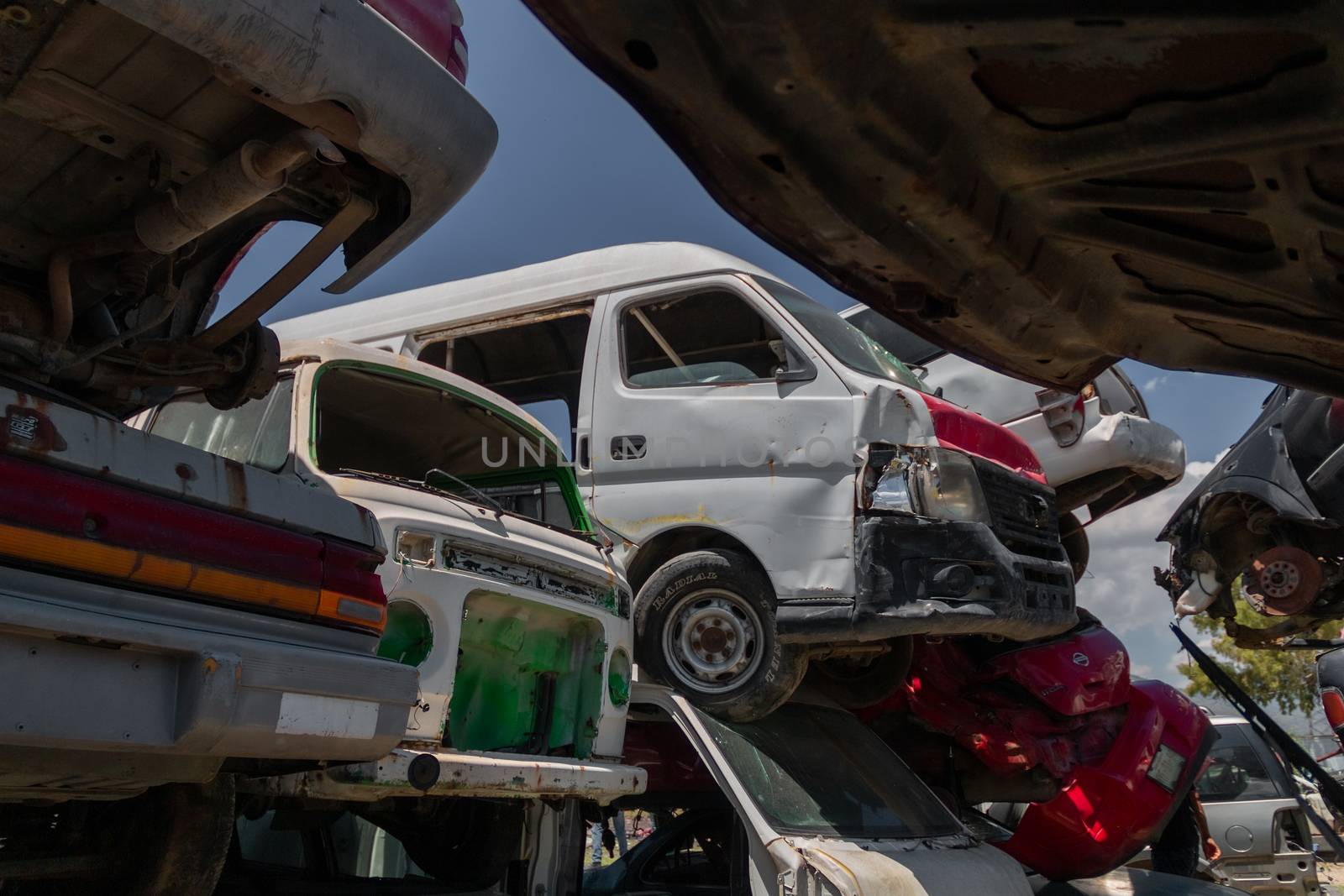 Mexico City / Mexico. June 19 2020: Old Cars Piled up in a Metal Recycling Yard Waiting to be Dismantled and Crushed. by leo_de_la_garza